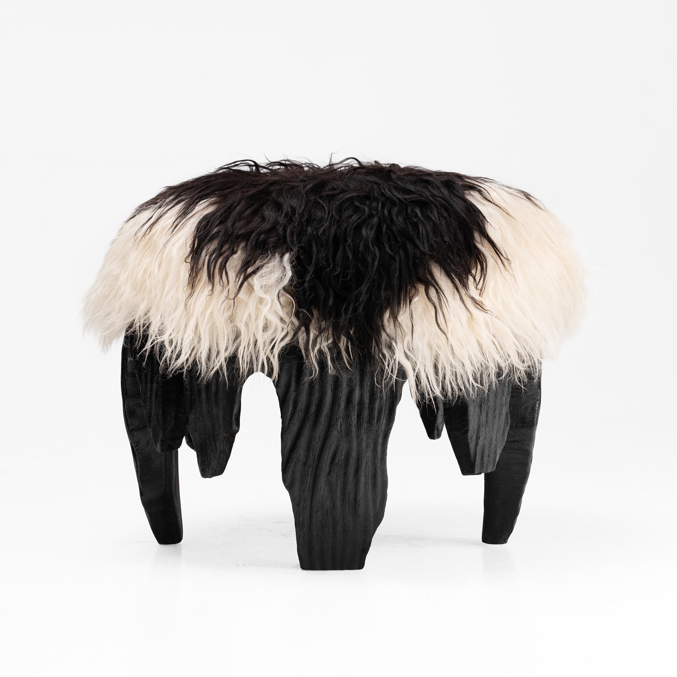 A tactile piece of domestic fantasy, the El Topo ottoman is a social object, featuring a carved Acacia base, burnt using the traditional method of Shou Sugi Ban and an animalistic, yet luxuriously soft, mottled monochrome Icelandic sheepskin