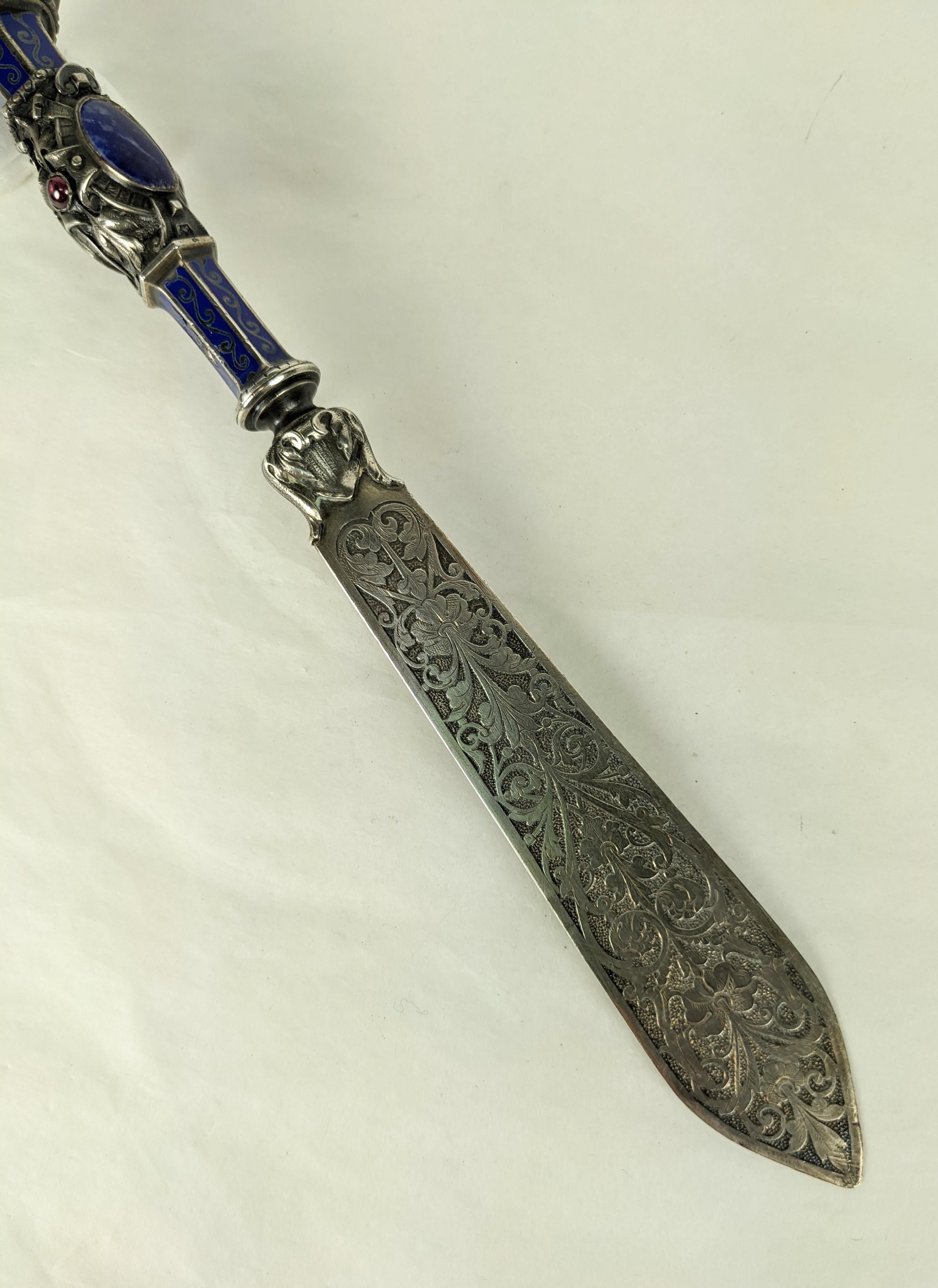 Elaborate 19th Century Sterling Silver Gothic Revivial Lapis Lazuli and Garnet Letter Opener. French in origin set with large lapis lazuli and garnet cabochons in elaborate silver Revivalist design on handle with Gothic Revival etching on blade.