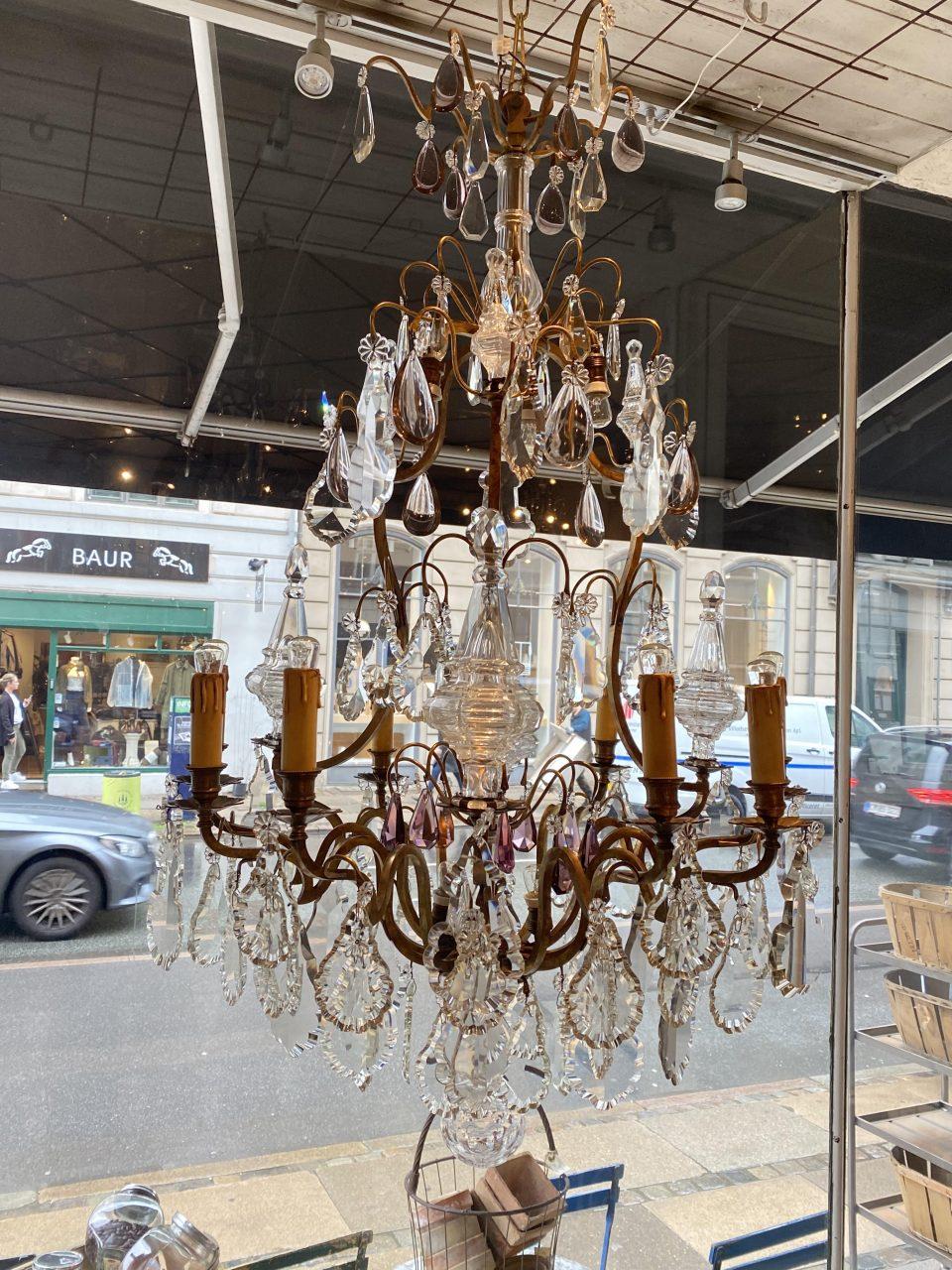 An elaborate and large antique cage-framed prism chandelier in gorgeous burnished brass, from circa 1900, France. Wonderful foliage shaped faceted prisms, and beautifully ornamental prism spiers and rosettes of glass in various sizes.

So special