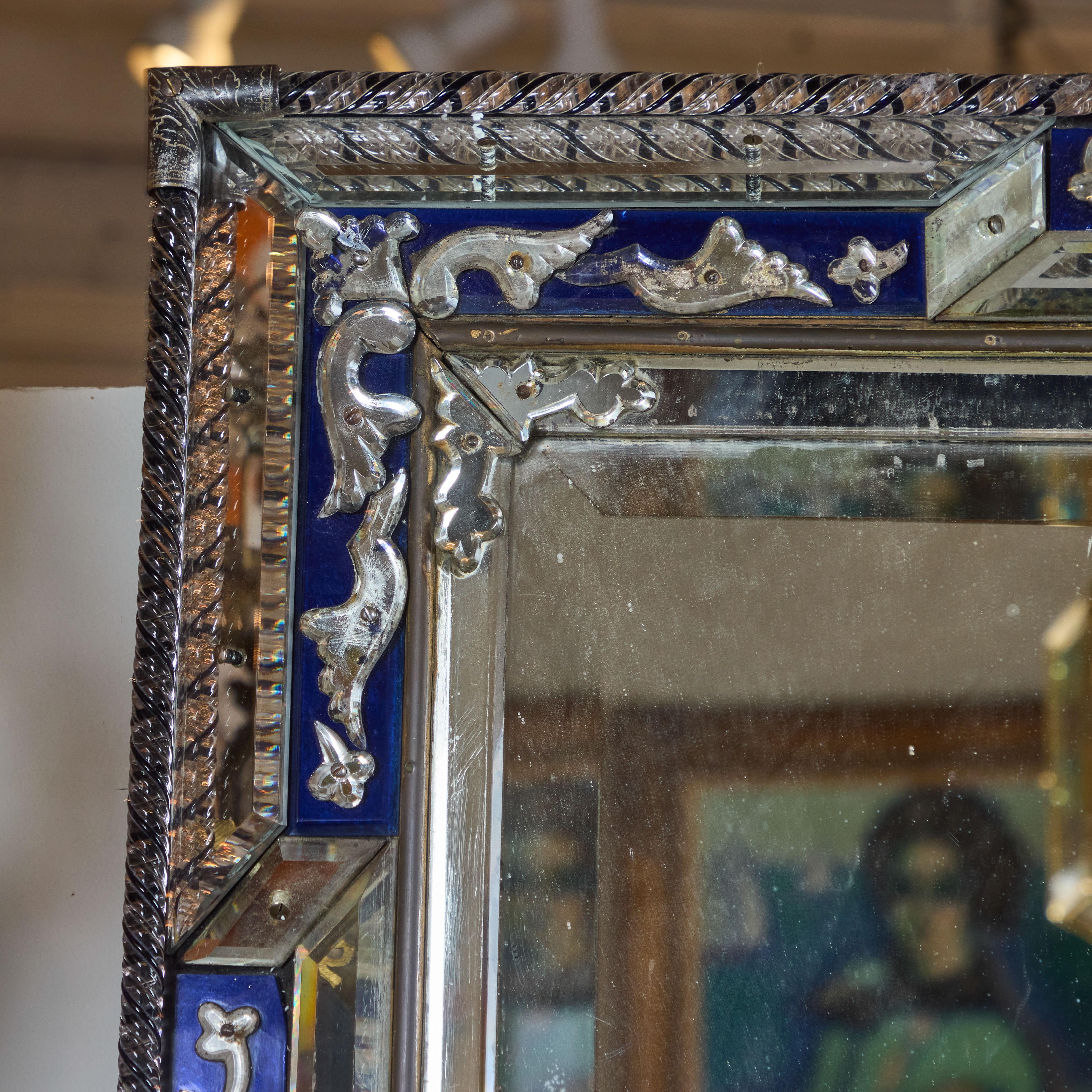 Elaborate cobalt glass mirror with twisted glass roping and metal corners. Original mirror has some light, age-appropriate loss to plaiting.  