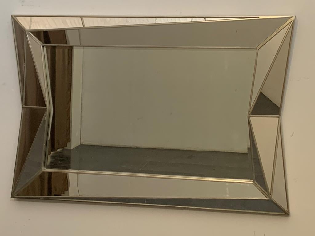 Unique and large silvered wooden mirror in the cubist style. Dating from the 1970s, it is assumed to be of French manufacture. Once placed it will be impossible not to notice its character and elegance, it gives a remarkable accent to your interior.