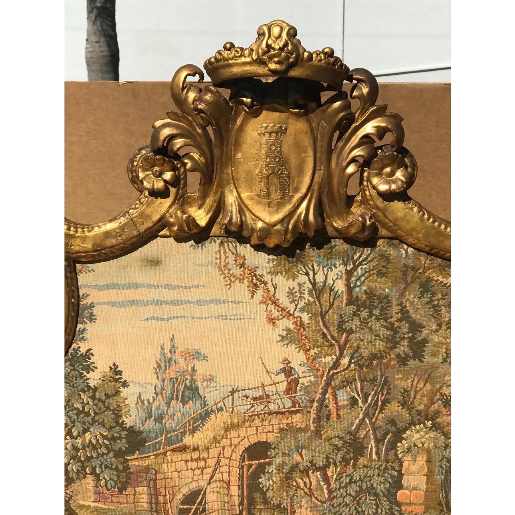 18th century Italian fireplace screen in elaborately carved giltwood, with a fine needlepoint insert.