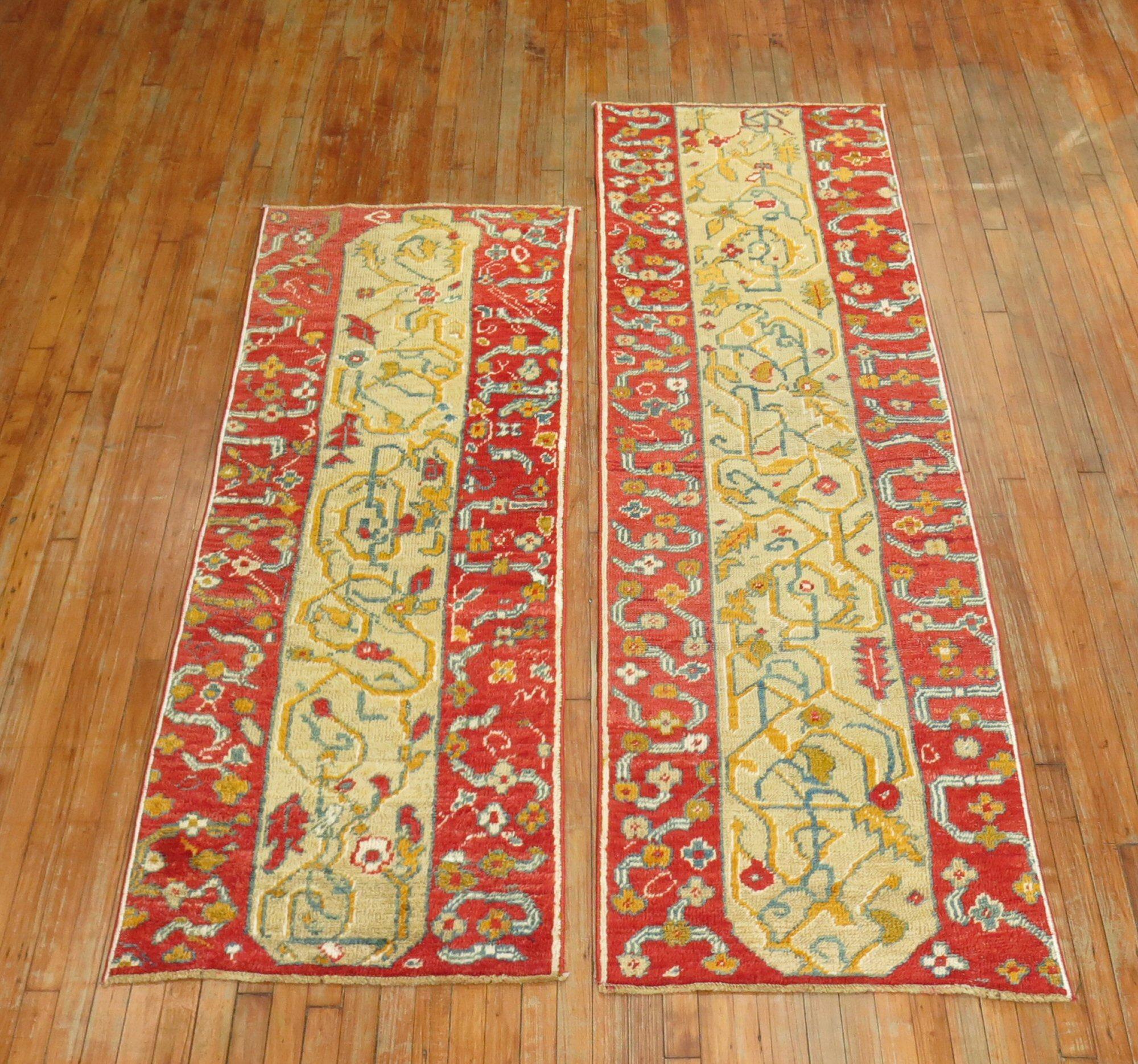 An elaborate pair of early 20th century Turkish Oushak runners with a camel field coral red border

Measuring: 2'6
