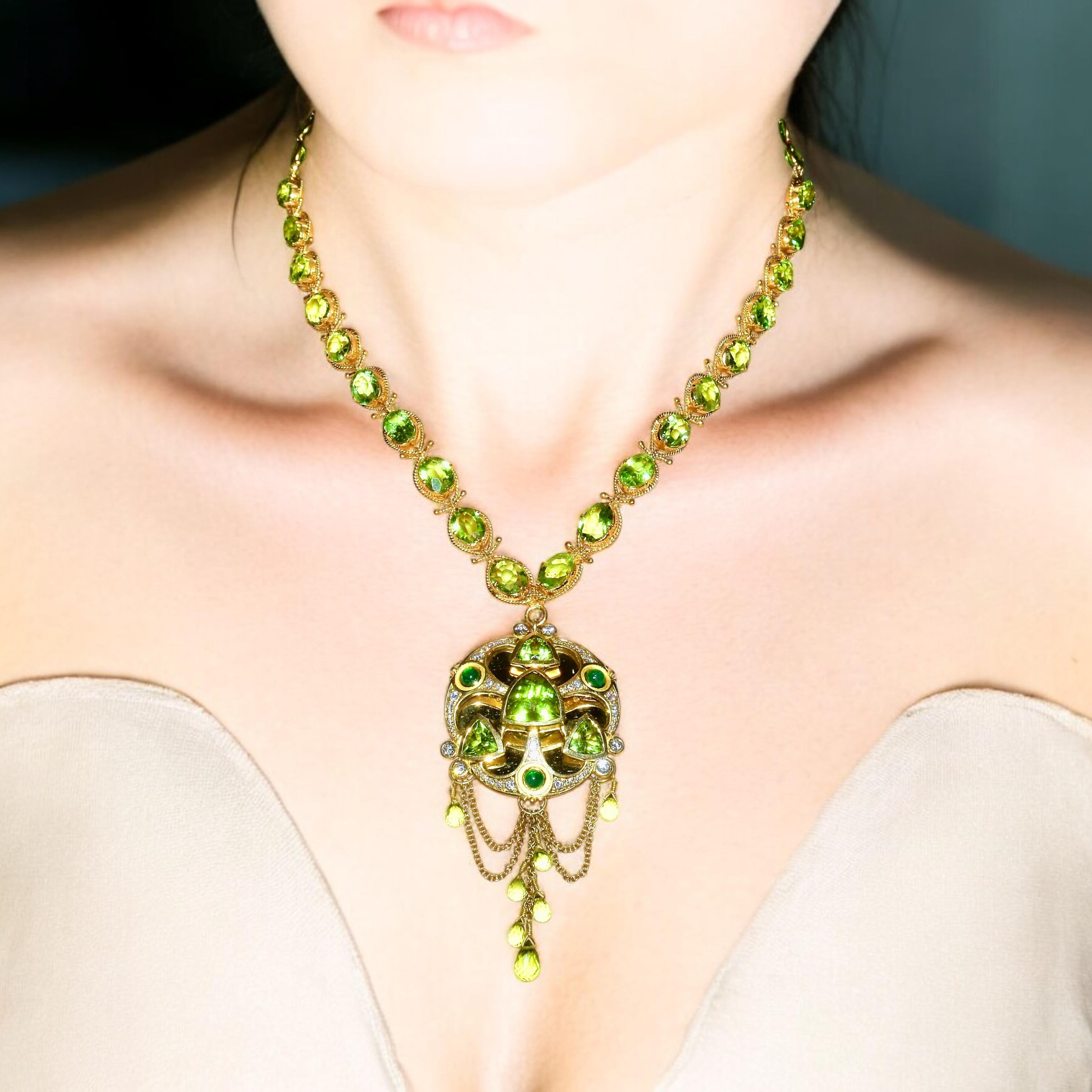 Fine natural Peridot, Emerald and Diamond contemporary necklace. The pendant portion of the necklace can be removed and worn separately as a brooch. Totally the necklace has approximately 90 cts. of fine well matched bright lime green peridot. The