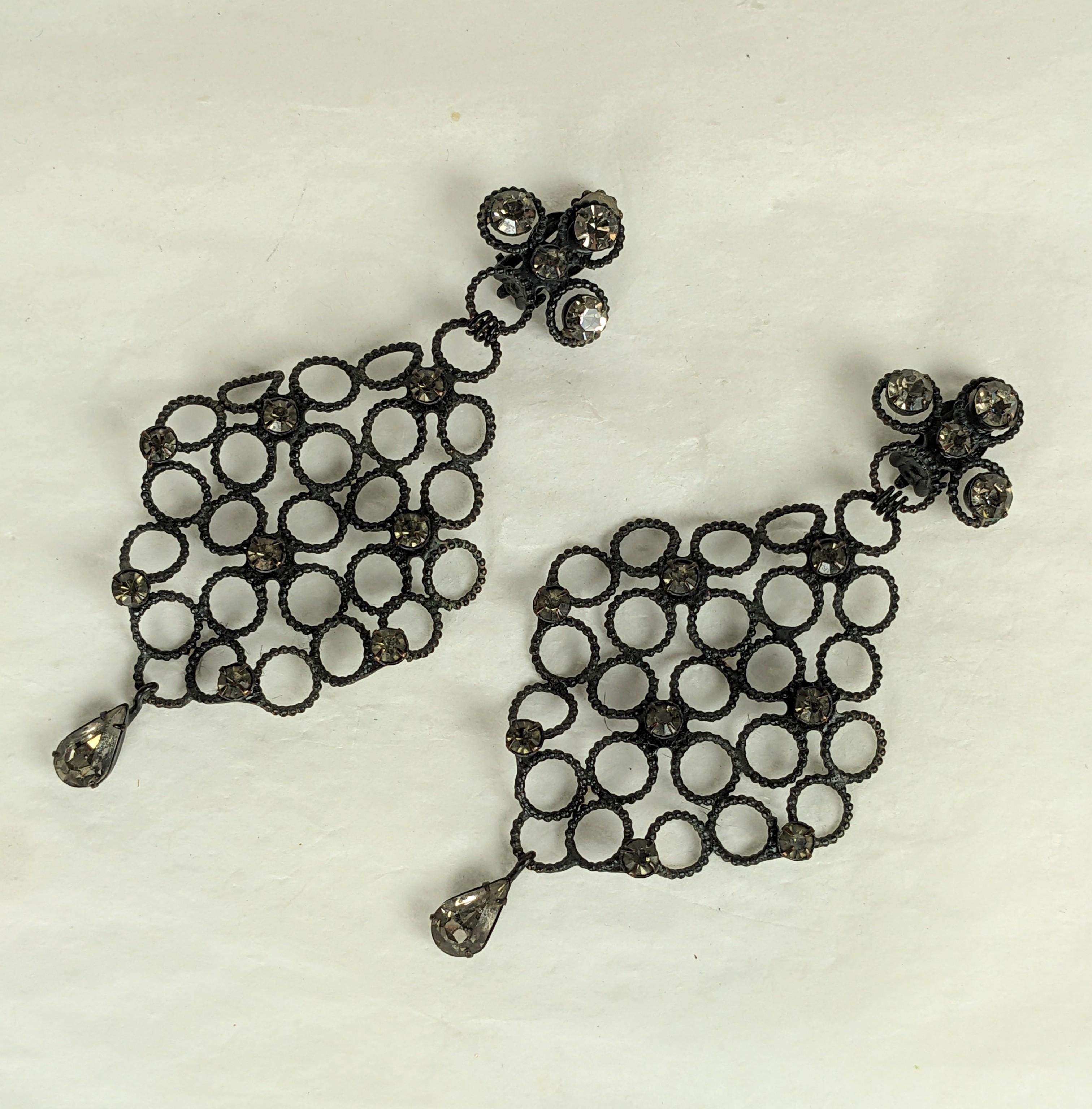 Elaborate and elegant Robert NY chandelier earrings from the 1960's in matte blackened metal with smokey crystals. Ribbed circles set high and low in a 3D formation. 4.5