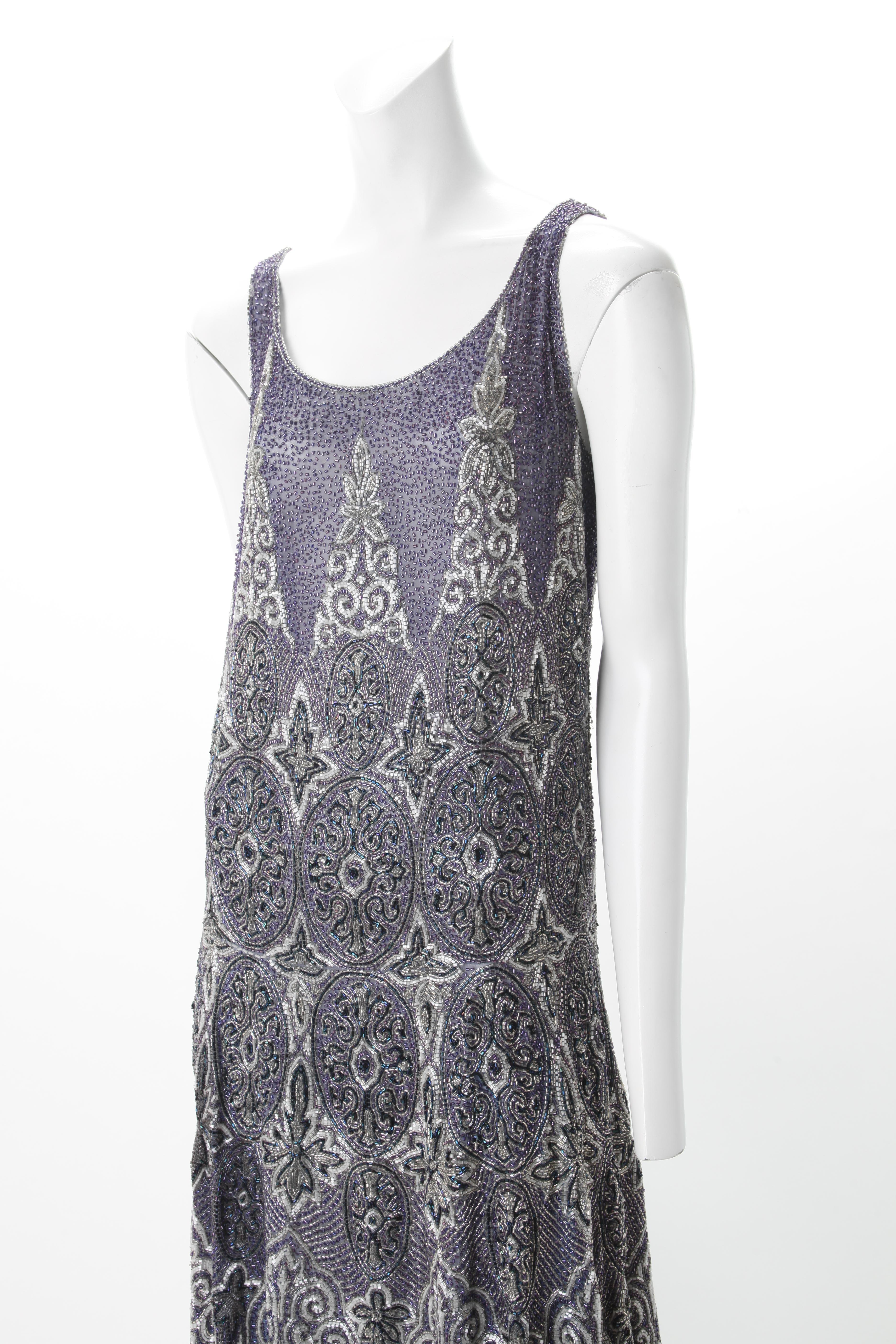 Elaborately Beaded French FLapper Dress, c.1920s
Indigo knee-length gauze Flapper dress with intricate beading of art deco style motifs in shades of indigo, blue and silver. Featuring the traditional scoop neckline and drop-waist design detail of