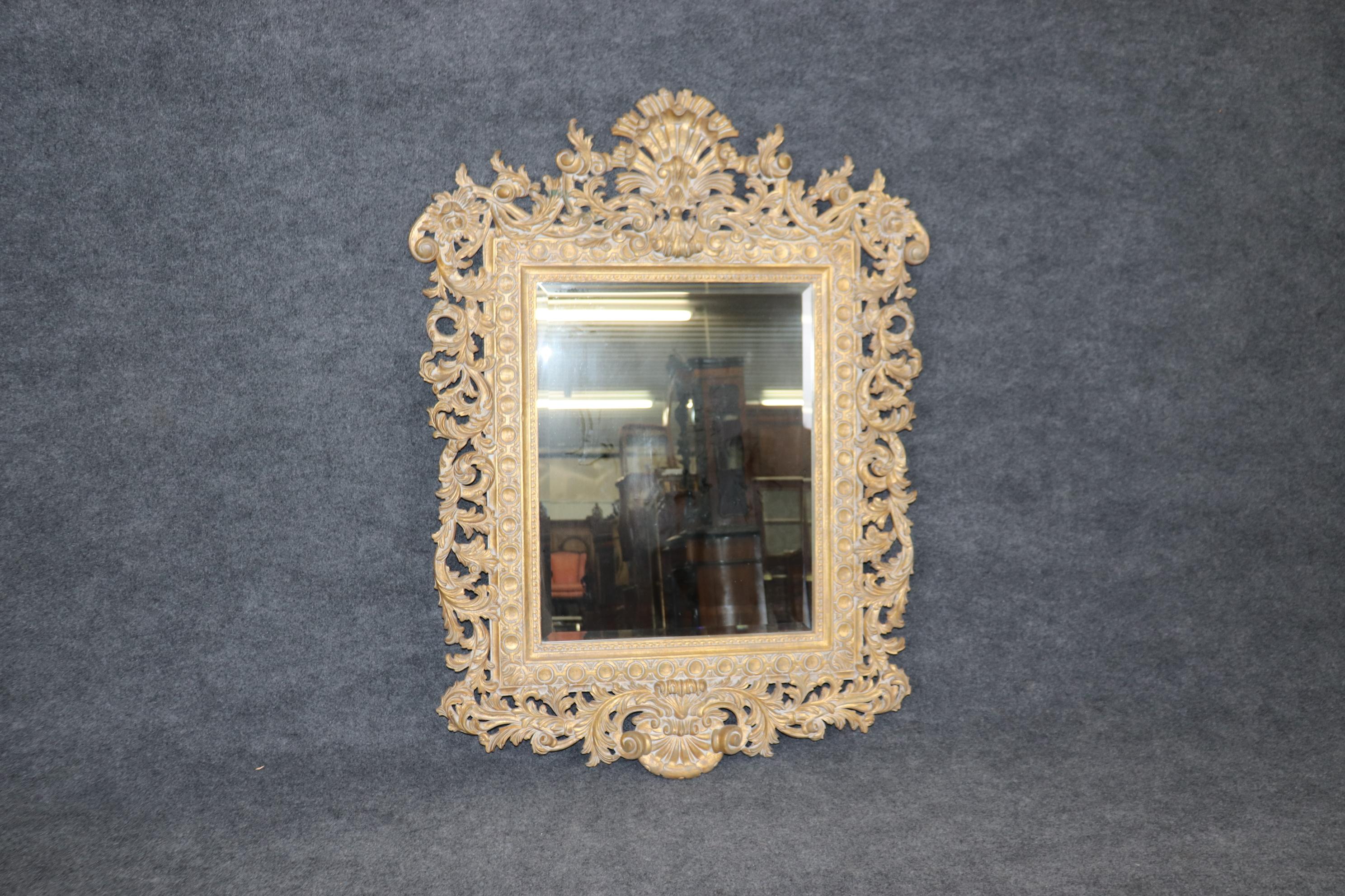 This is a superbly crafted, ornately hand-carved LaBarge mirror. LaBarge made their mirrors in Italy. The quality of their frames are world renowned for being the best carved in the business. The finish is a gorgeous pale genuine gold leaf finish