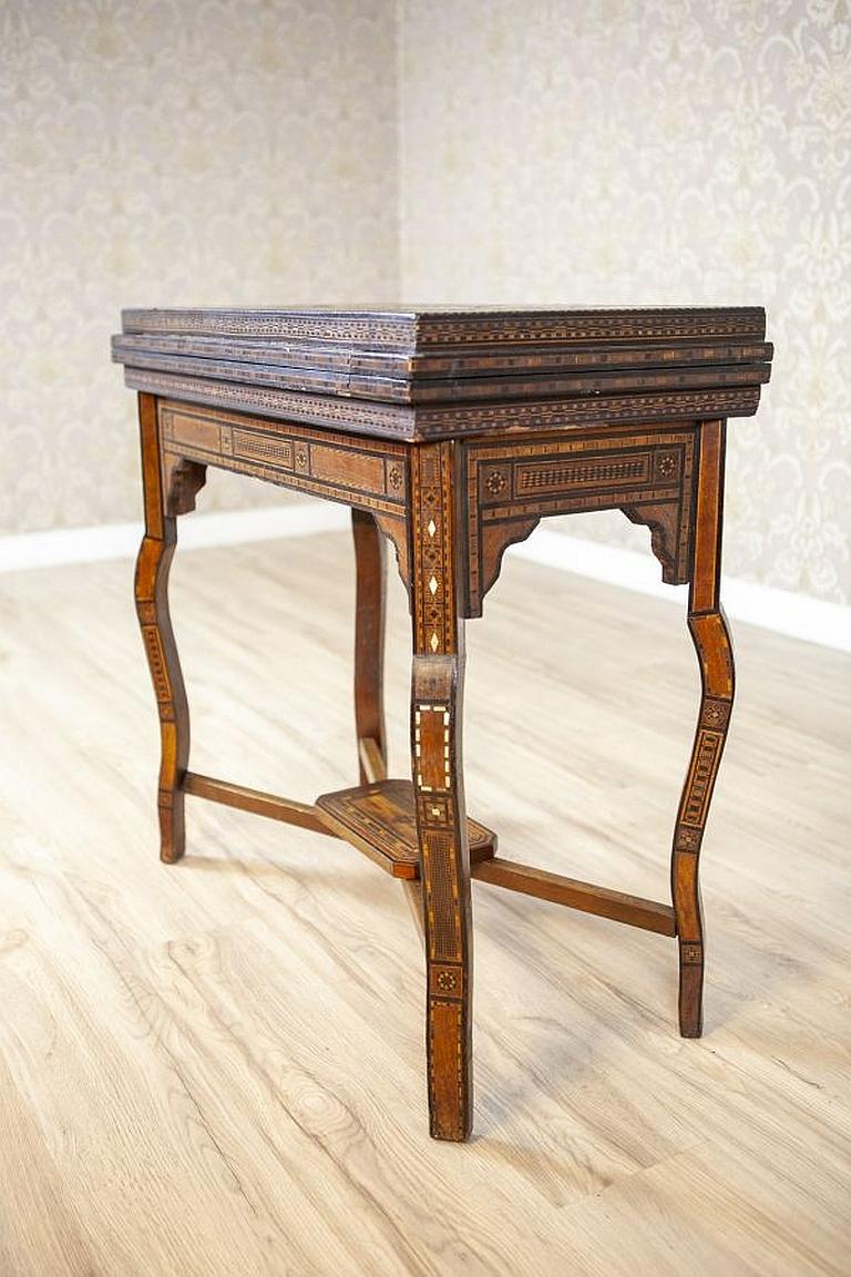 Elaborately inlaid Spanish game table from the late 19th century.

We present you this beautiful table that can be used for playing chess, backgammon, and cards. The whole surface is covered in splendid and elaborate inlays. The table is placed on