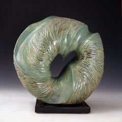 “Aqua Incision”, blue green circular ceramic, carved with flowing water lines 