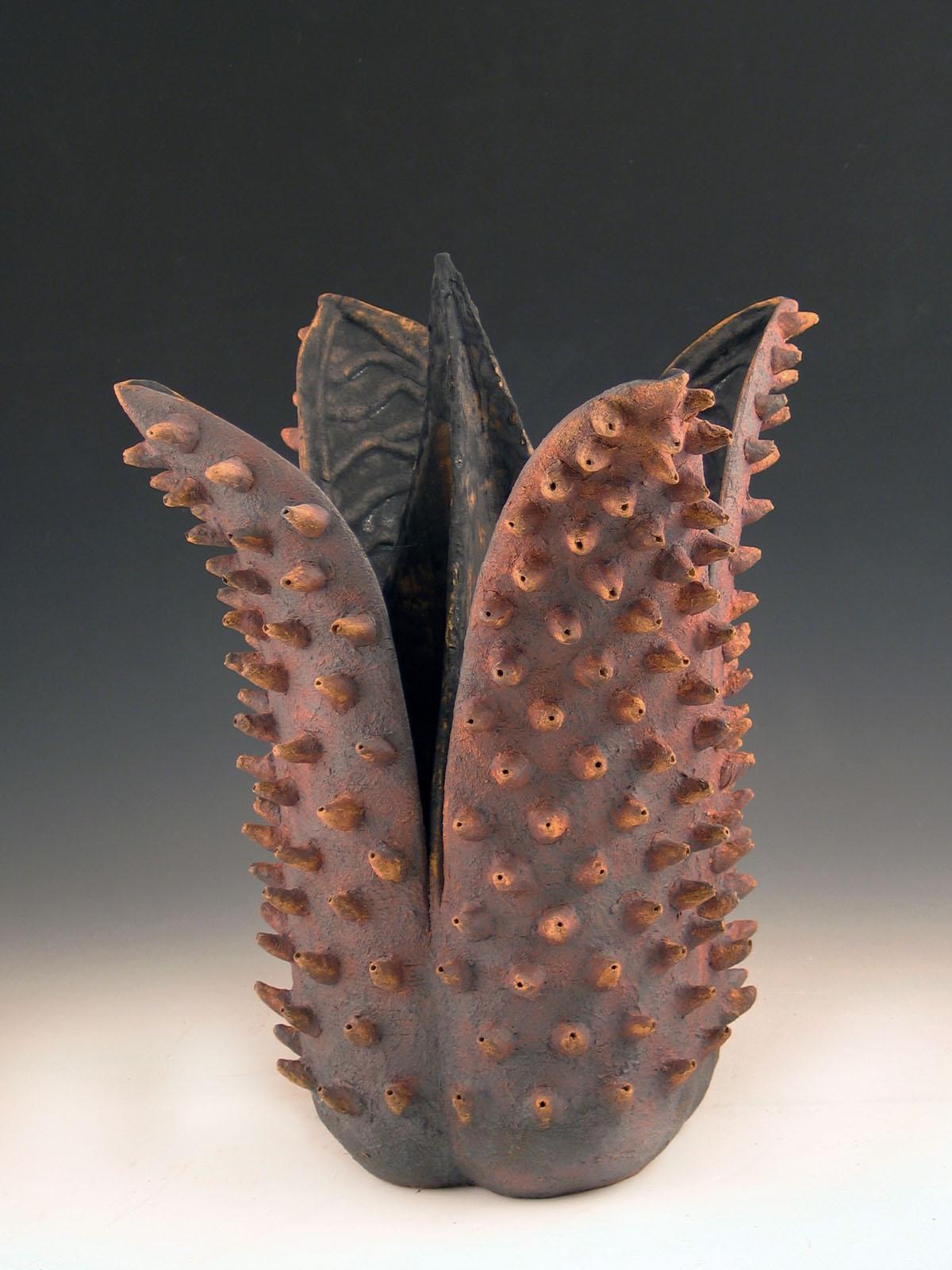 Elaine Lorenz Abstract Sculpture - “Bristled Beauty”, a fantastic flower with, black interior with iron red petals 