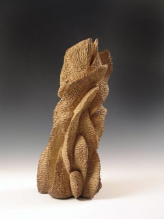 "Growing Out”, a warm golden natural form in textured ceramic evokes summit