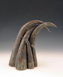 “Moving On”, sheaf of curved ceramic forms in deep browns