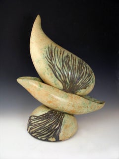 "Precarious Perch”, green and light brown ceramic balanced daringly
