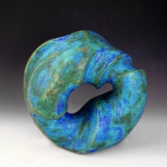 “Prime Mover”, blue-green circular ceramic carved with flowing water lines