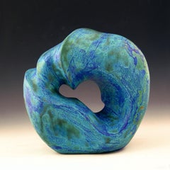 “Prime Mover”, blue-green circular ceramic carved with flowing water lines 