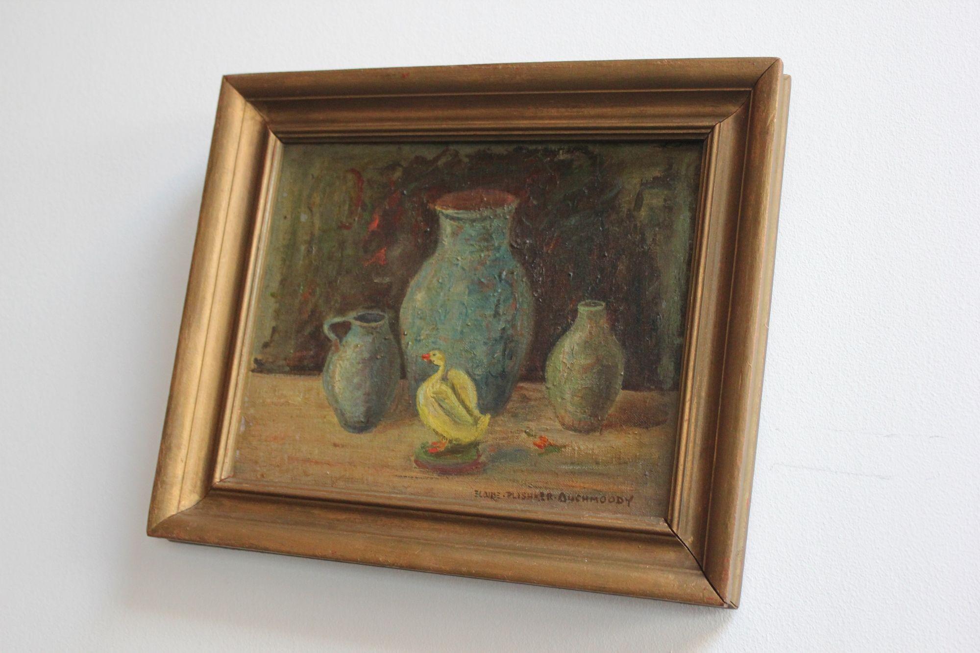 Still life oil painting ca. 1940s depicting a 'duck' figurine amid vessels by Elaine Plishker Auchmoody (b. NYC 1910 - d. Massachusetts 1976).
Auchmoody was a highly-regarded lecturer and esteemed painter whose work was exhibited in notable