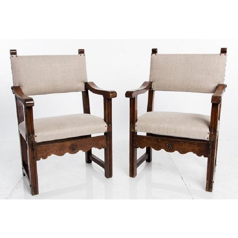Pair of antique English elbow armchairs, circa 1910. Wear is consistent with age. Decorative front apron. Seat depth 14.5