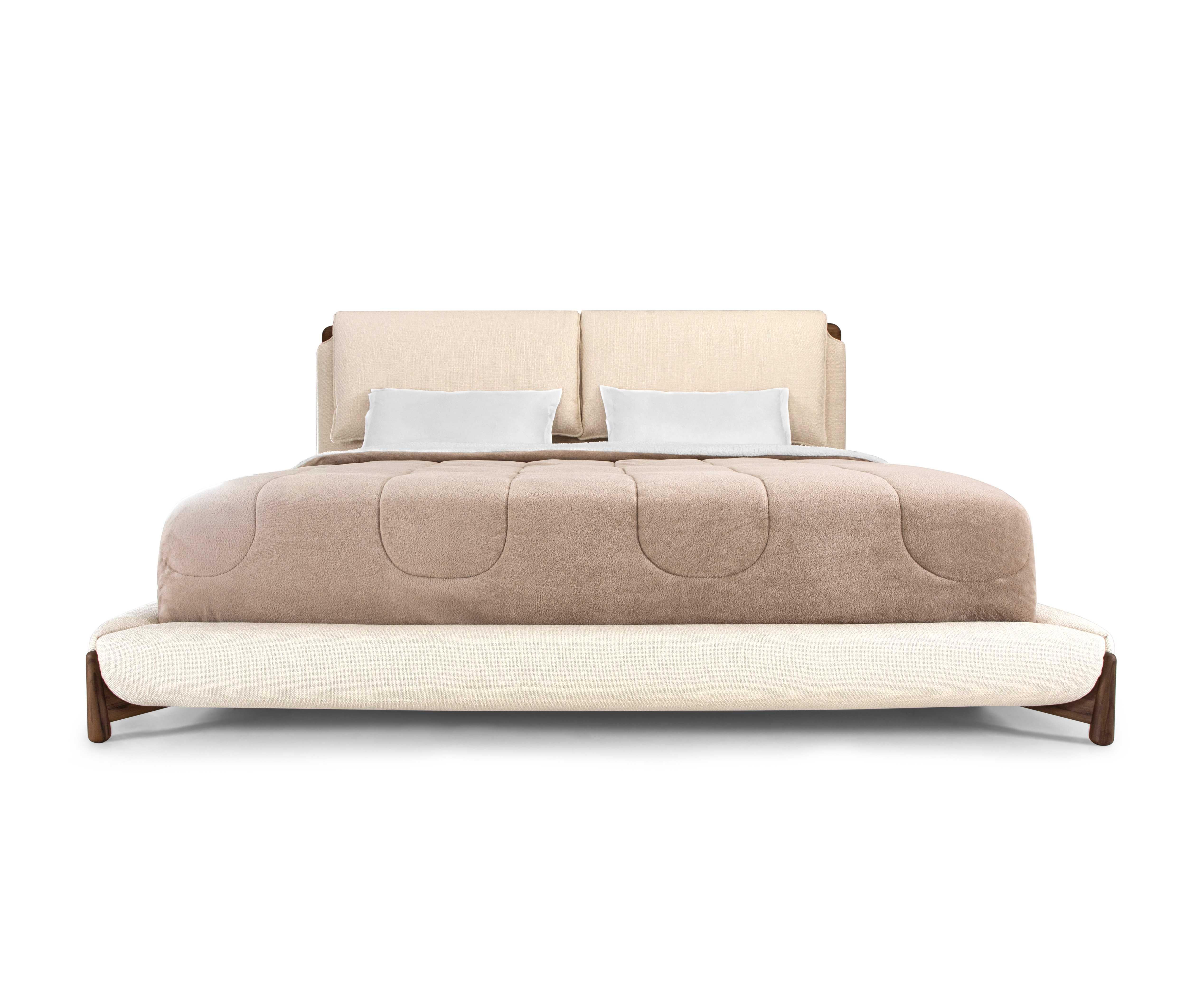 An Elbow Queen bed designed by Studio + A! for Uultis, with ivory fabric and walnut finish. The Elbow Queen size bed combines contemporary elegance with timeless comfort, making it a standout feature in any modern bedroom. Upholstered in soft Ivory
