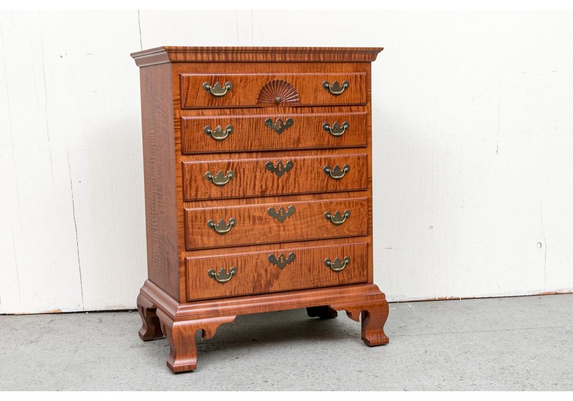 Eldred Wheeler diminutive Chippendale style tiger maple chest with 5 drawers. The chest with shell carved top drawer, brass drop pulls, ogee bracket base, inlaid side banding. Bears the Eldred Wheeler label inside drawer.

Dimensions: 21 3/4