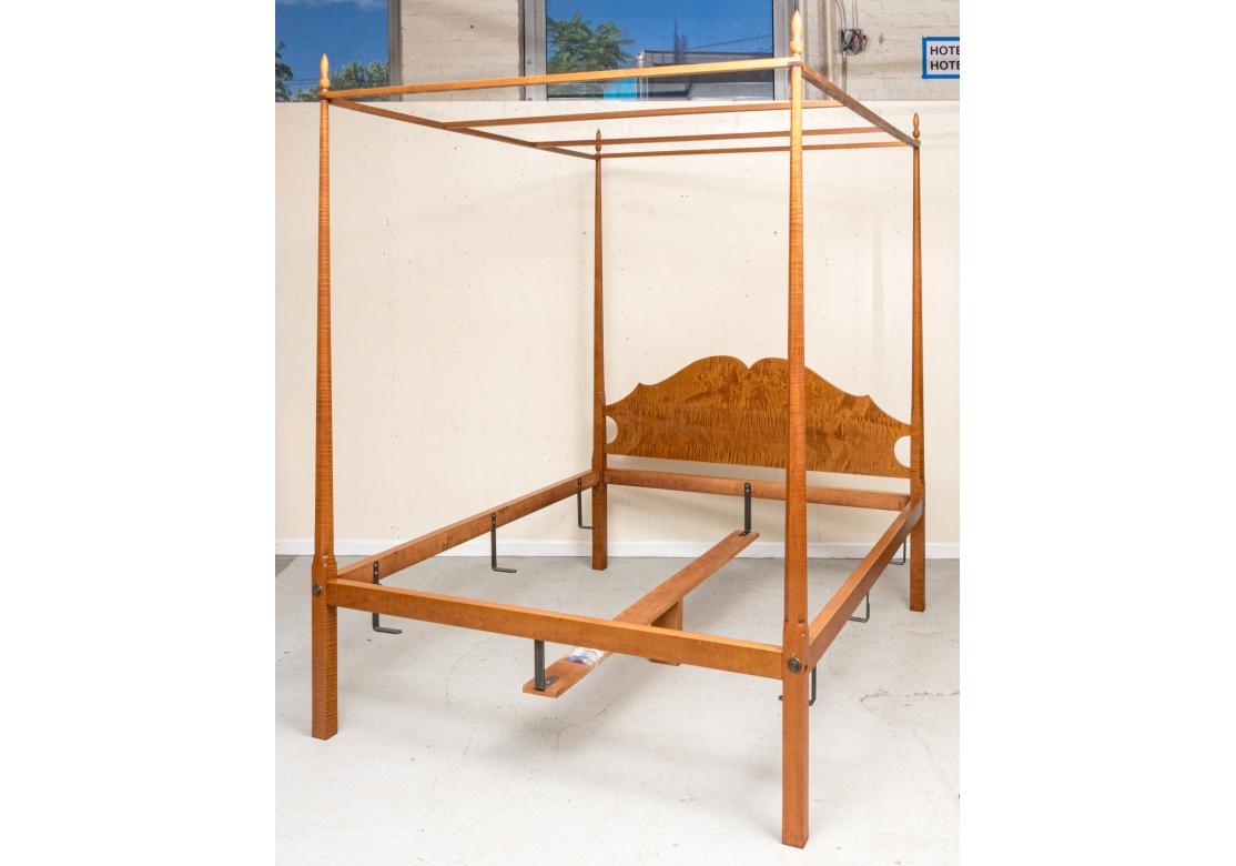 Eldred Wheeler tiger maple queen sized pencil poster bed complete with metal hangers, box spring center support, screw covers, elongated finials and canopy frame. Bears the Eldred Wheeler label and incised name on back of headboard.

Dimensions: 84