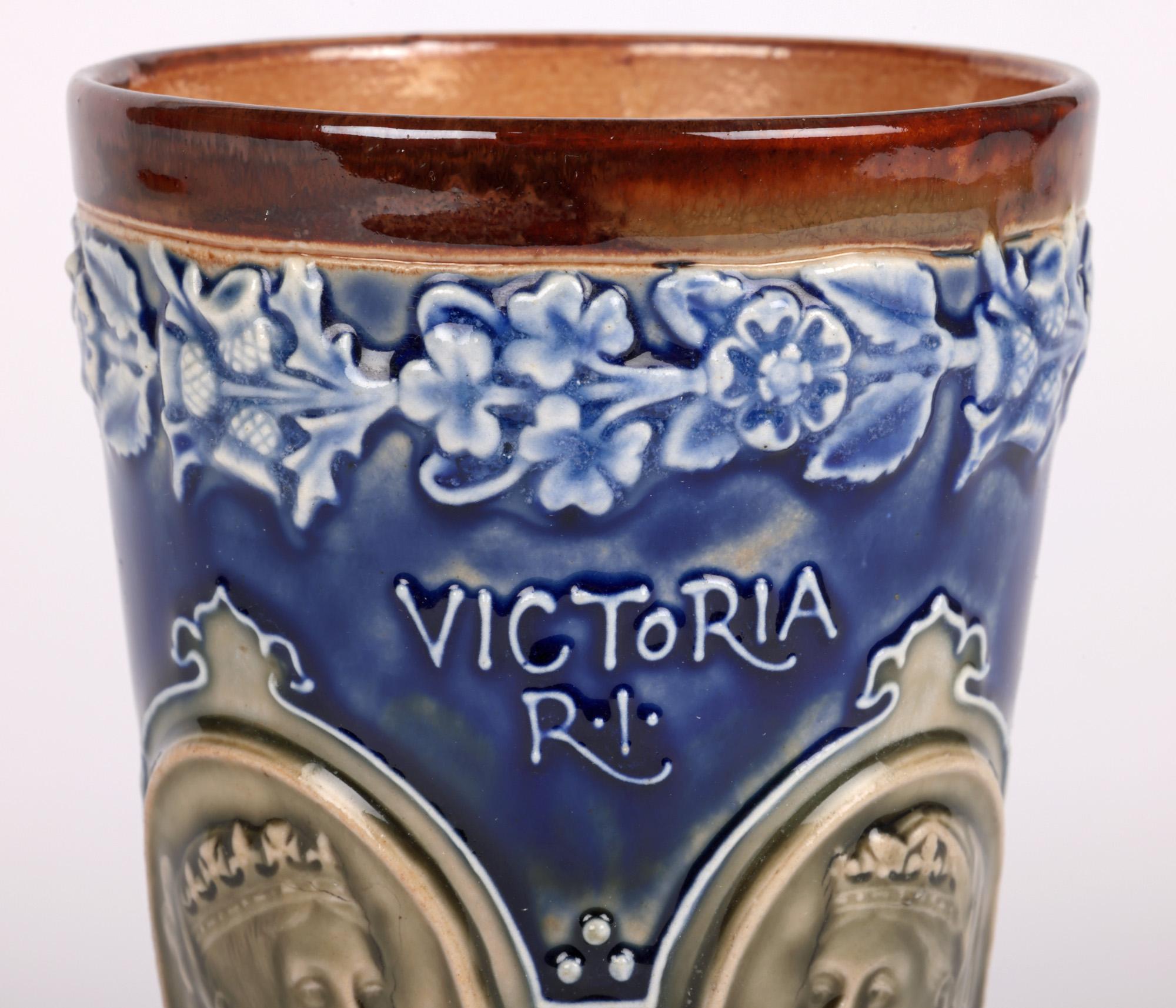 A fine Doulton Lambeth beaker commemorating Queen Victoria’s diamond jubilee by renowned artists Elizabeth Atkins and Eleanor Tosen and dating from 1897. The stoneware beaker is of simple funnel shape standing on a narrow flat round base with the