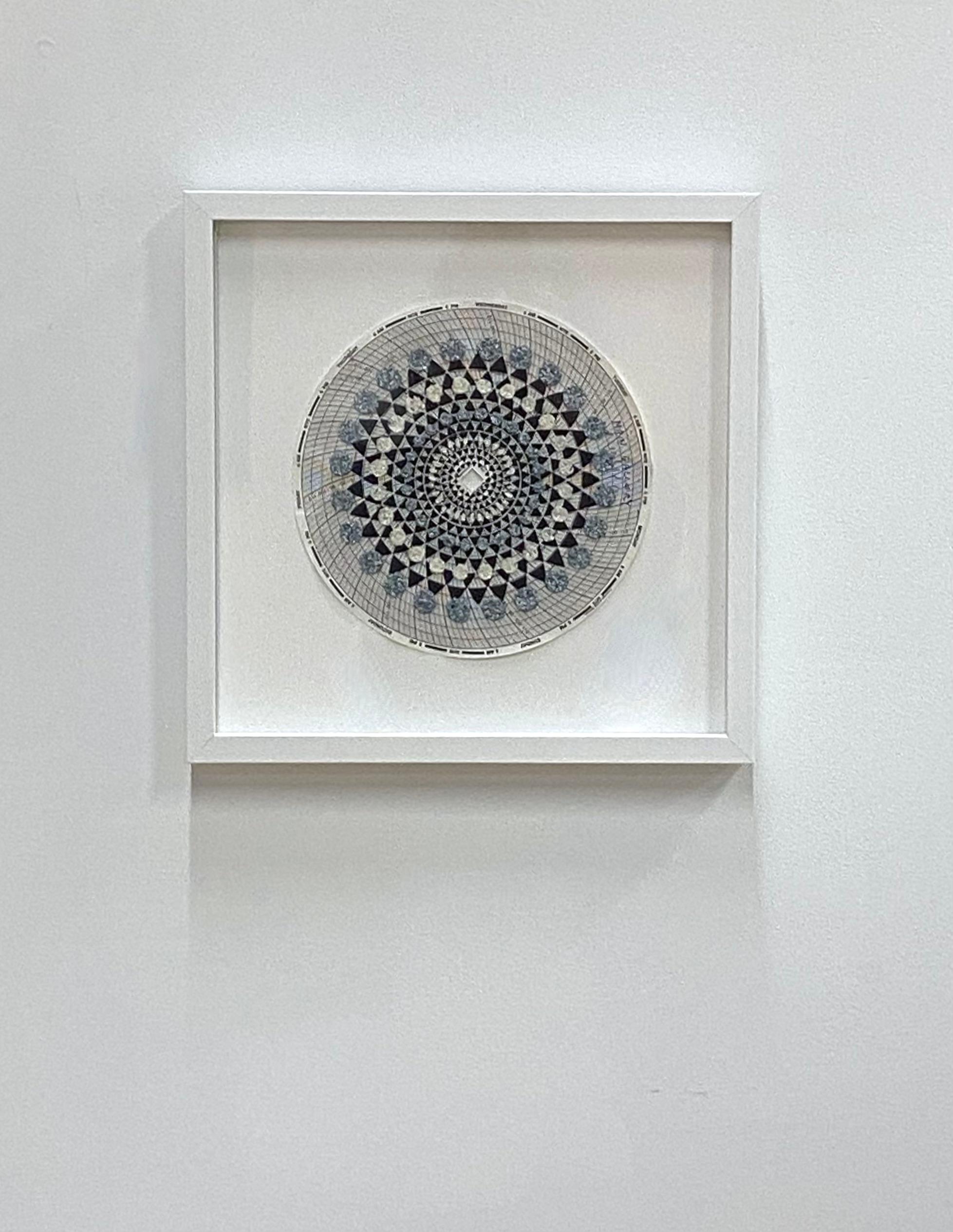 Carefully applied layers of emu eggshell and chicken eggshell, wood ash and polymer medium on hygrothermogaph paper create surface texture in this mandala made up of intricate patterns in an ordered, symmetrical, circular composition in blue, brown