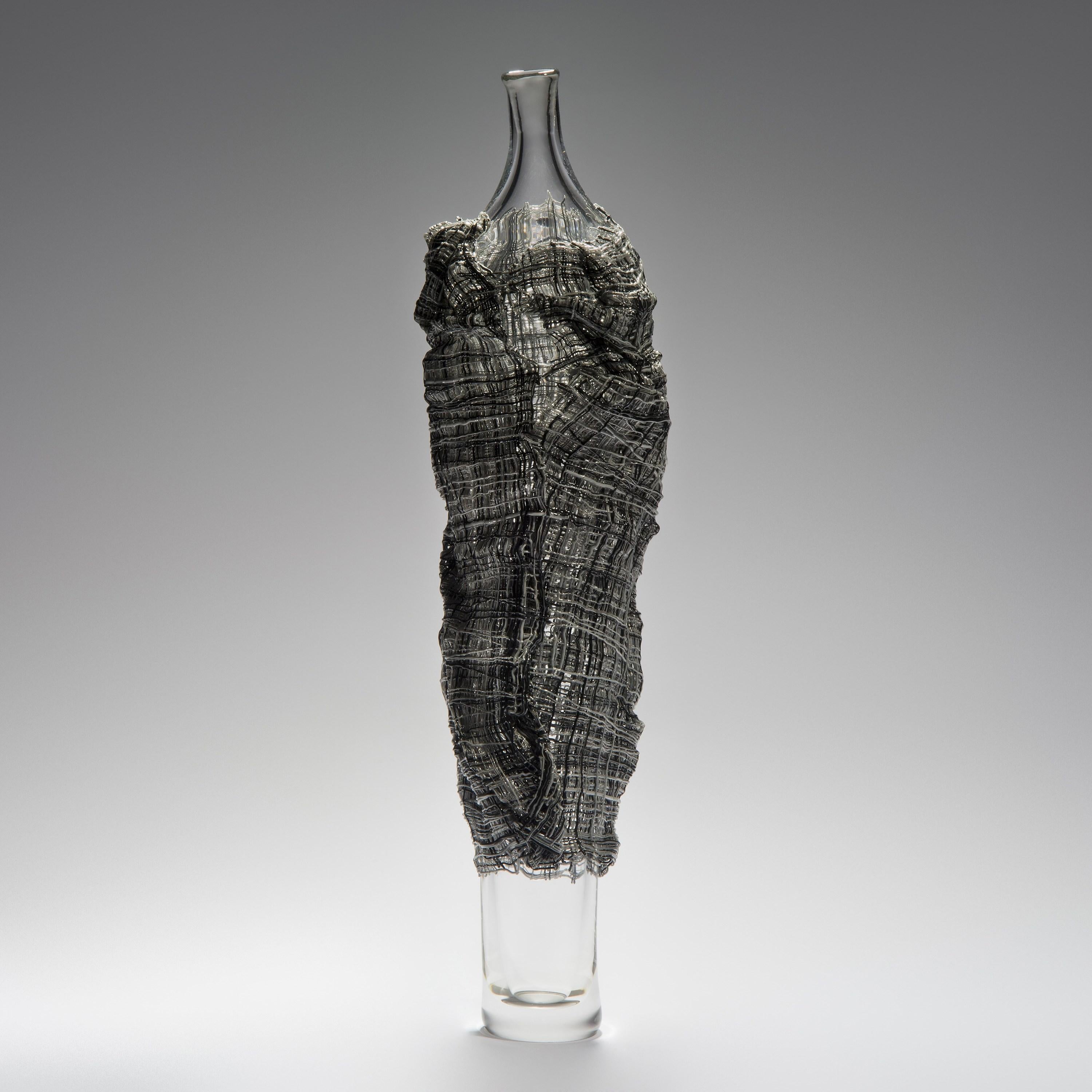 'Electra' is a unique glass sculpture by the British artist Cathryn Shilling. The interior figure is free-blown glass which is wrapped in kiln-formed glass cane 'fabric' which is applied hot. With her Cloaked Collection, Shilling takes mythical