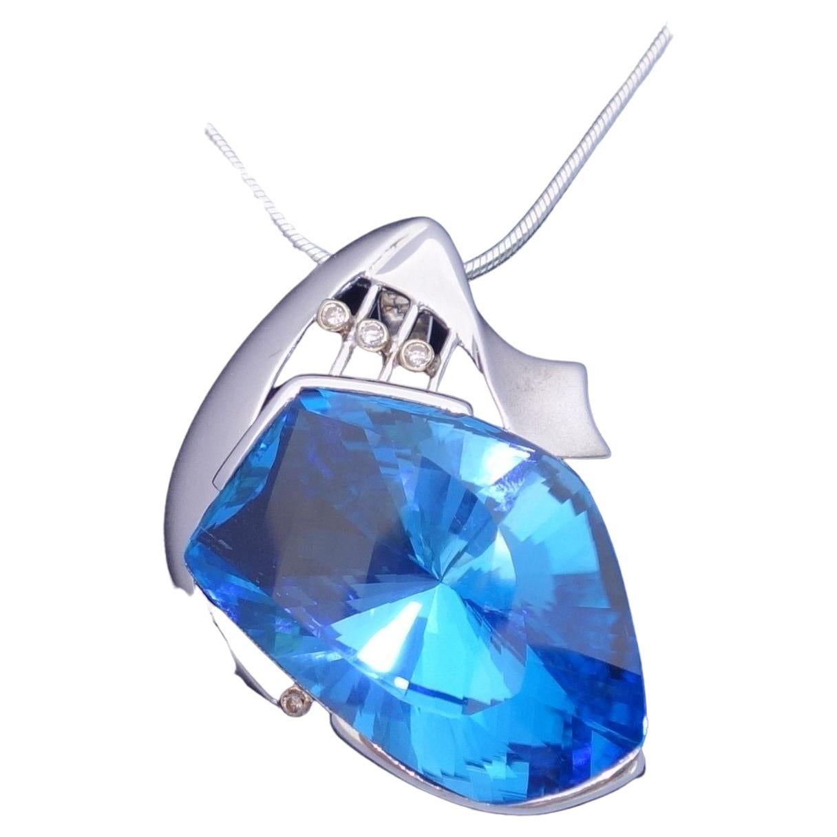 Simply Beautiful! Electric Blue and Diamond Gold and Sterling Silver Pendant Necklace. Centering a Fancy cut Electric Blue Topaz, Stone Size: 33mm x 22mm. Accented by 2mm 3 small Natural Diamonds. Suspended from an 18” long Sterling Silver 1.6mm