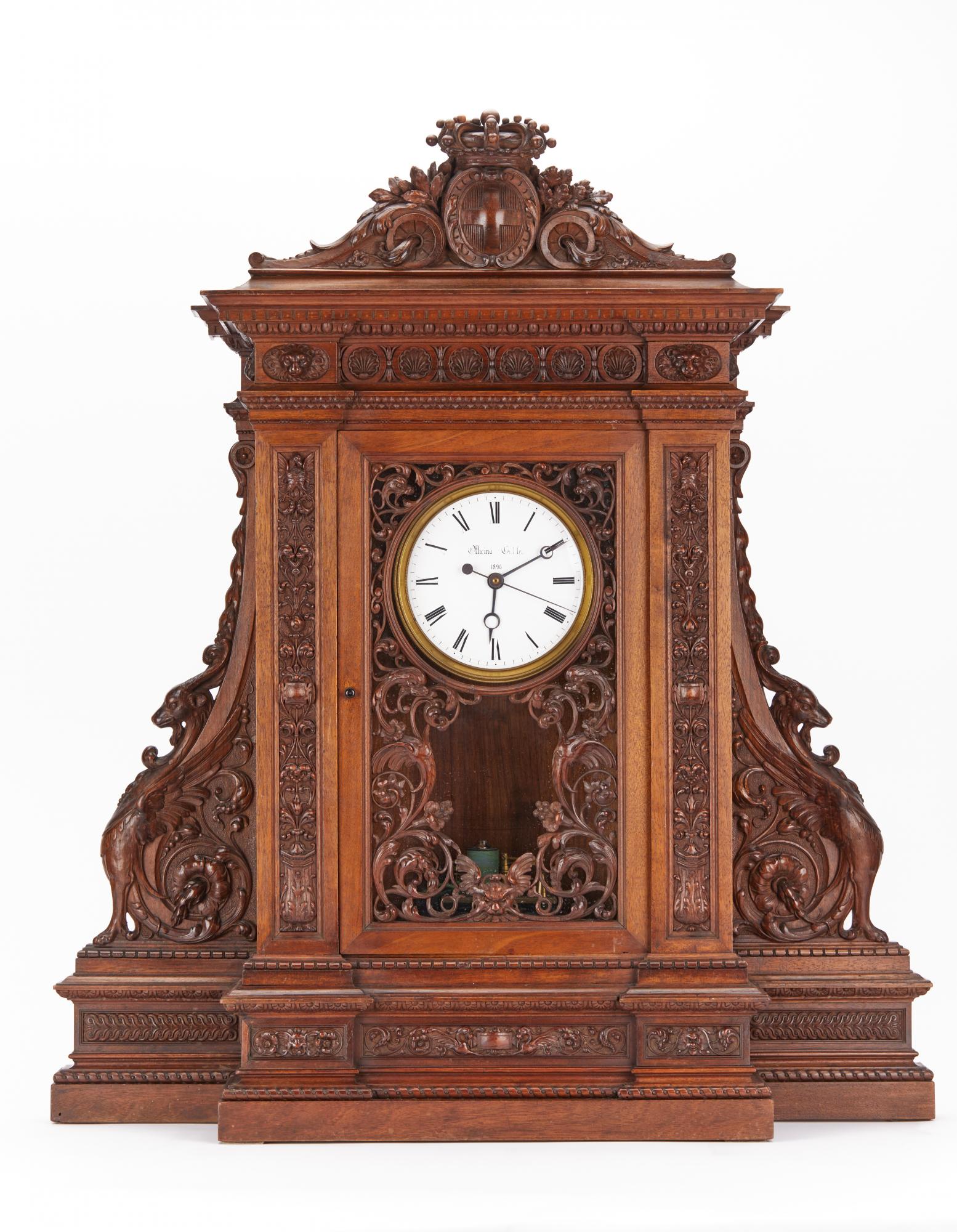 An exceptional rare and important early electric oak finely wood carved mantel clock from MATTHIAS HIPP.

The beautiful wood carved case with in the top the coats of arms from a noble family from the north of Italy . Mathias Hipp was one of the