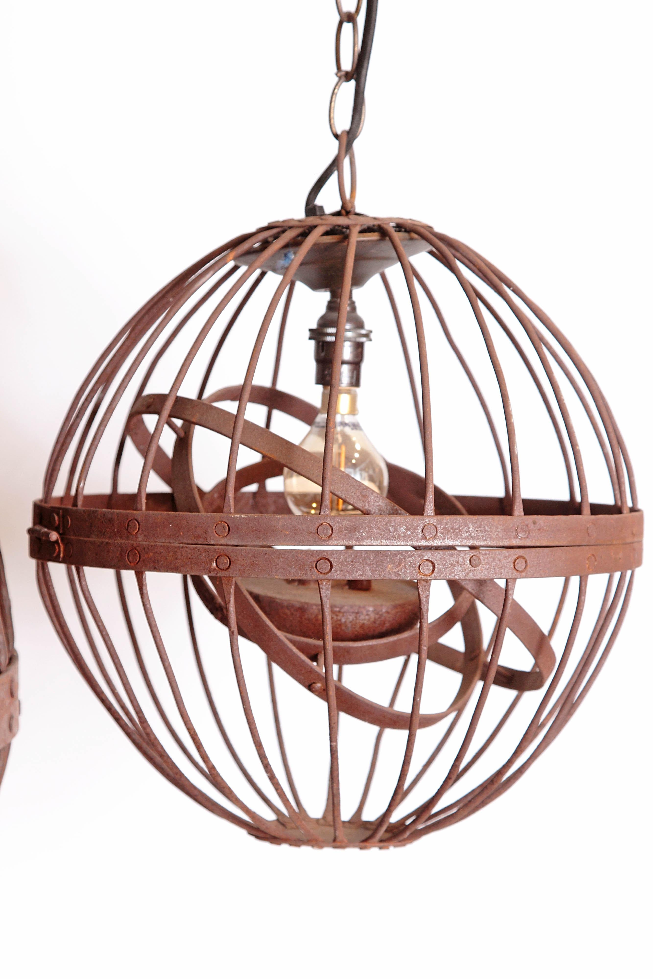 Three 19th century, now electrified, gyroscopic whale-oil lamps constructed of iron ribs with a triple gimbal to steady the burning flame in the heaviest seas or winds. Two of the lamps measure 12