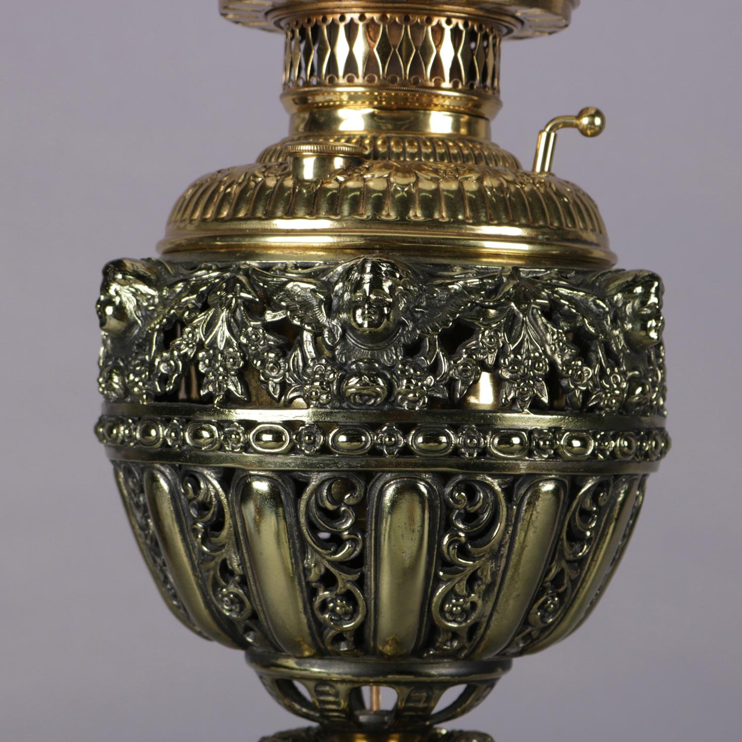 Antique electrified Gone-With-The-Wind table lamp features hand-painted globe with roses above pierce scroll and foliate brass font and raised on an onyx column seated on pierced and footed base, circa 1890.

***DELIVERY NOTICE – Due to COVID-19 we