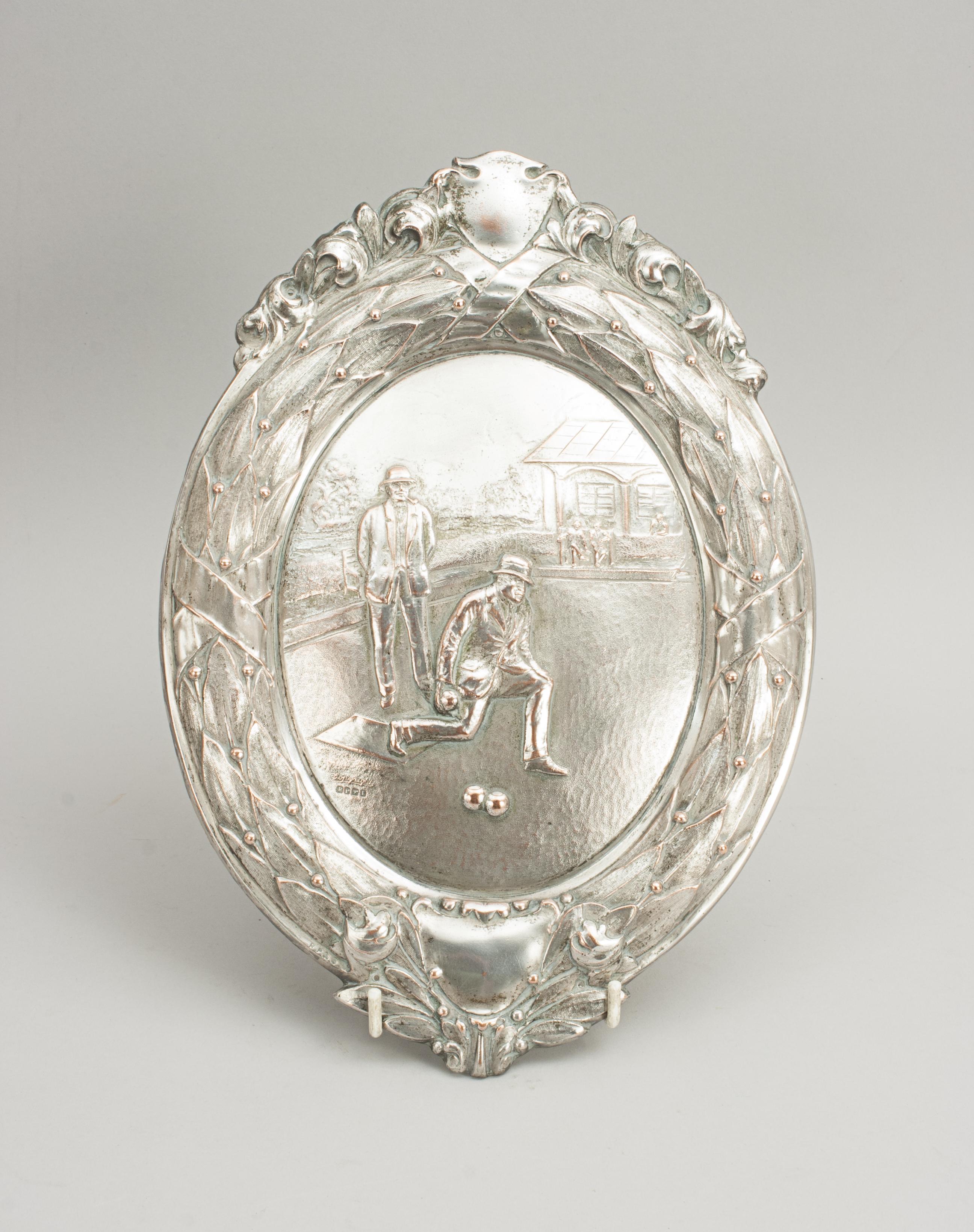 Antique Lawn bowls trophy shield centerpiece.
A wonderful bowls electroplated metal plaque with decorative sides and ends. This was probably made as a front piece for a larger trophy or shield. The scene engraved on the plaque is of two males
