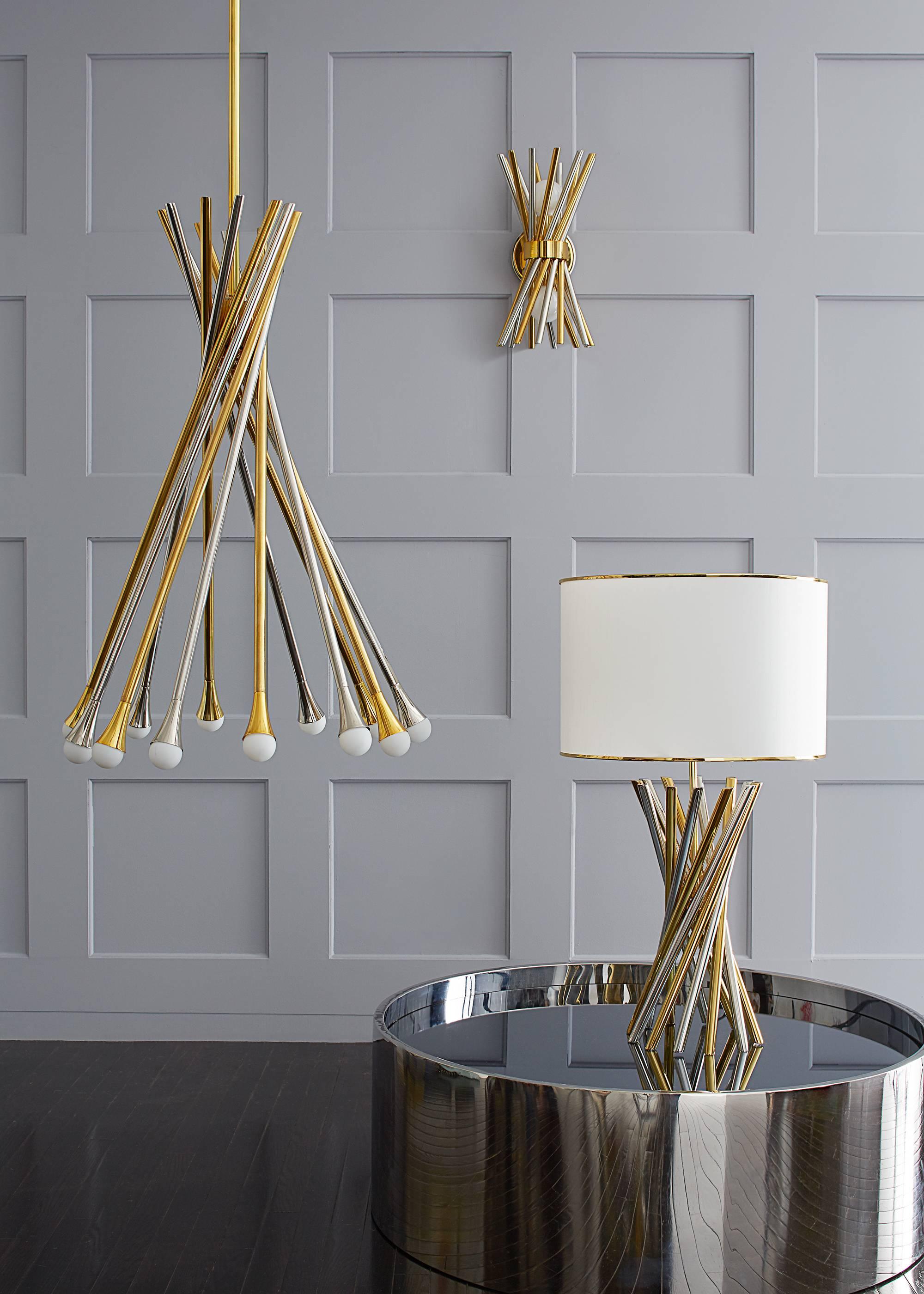 Mixed metals. A swirling constellation of polished brass and polished nickel rods topped with mirrored glass, our electrum accent table is the perfect cocktail perch. With a simple, but kinetic form and a glamorous combo of brass and nickel, our
