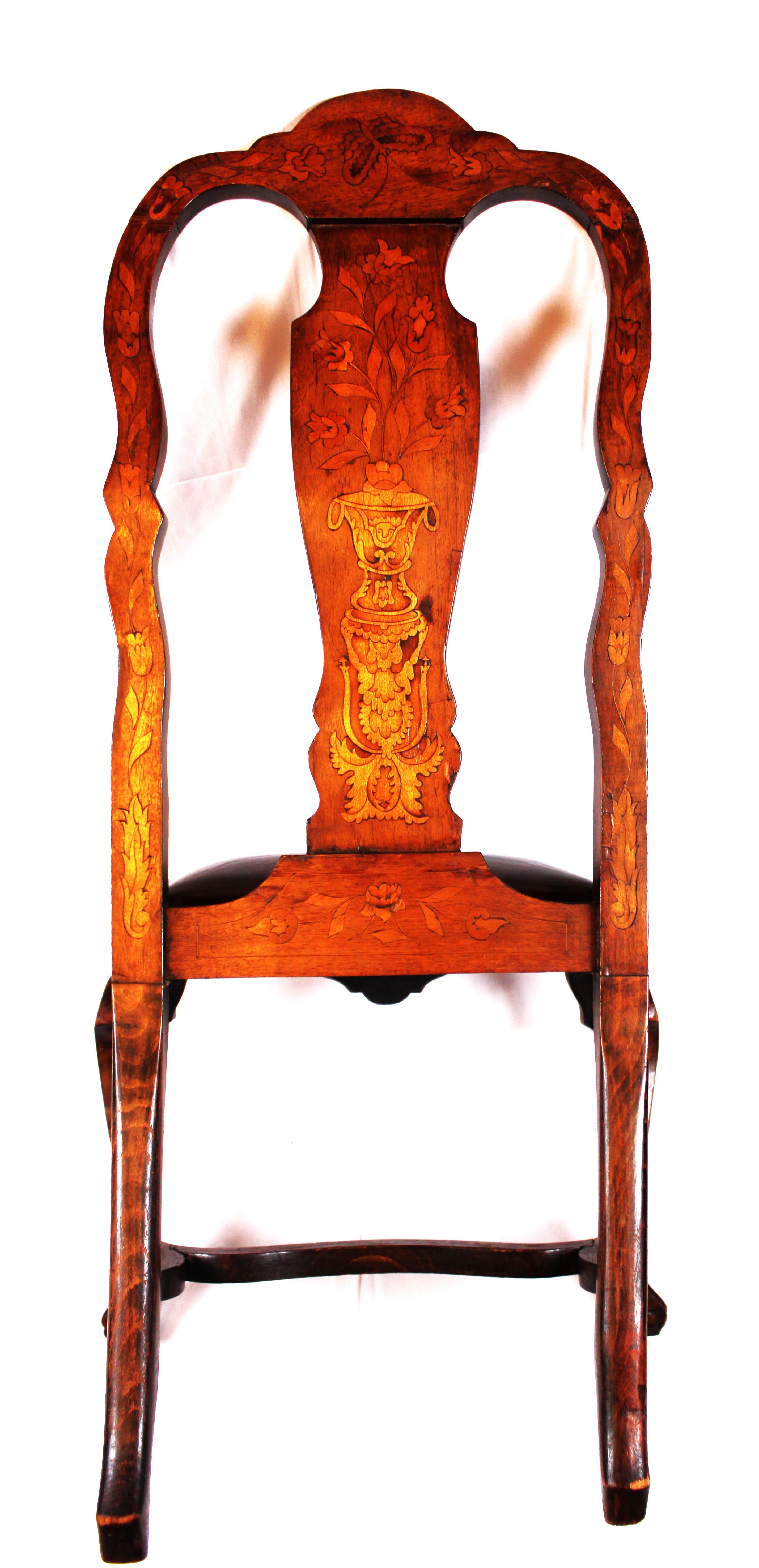 This remarkable 19th-century Dutch dining chair seamlessly blends artistry and functionality. Crafted from rich walnut, it stands as a testament to the skilled hands that shaped it.

Intricate Marquetry Inlays: The chair’s backrest is a canvas of
