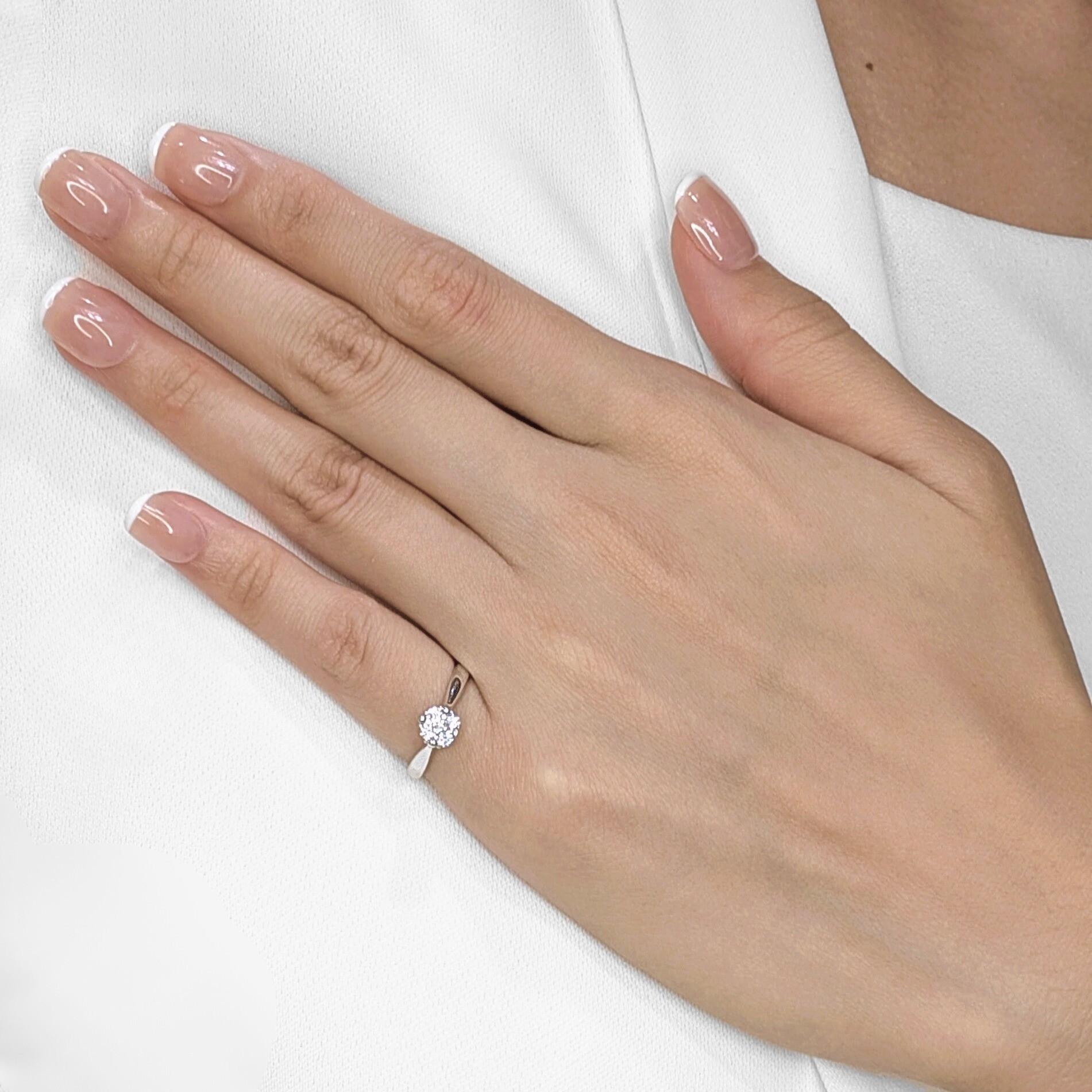 Adorn your hand with the charming sparkle of this cluster ring, meticulously crafted in lustrous 9K white gold. Five brilliant natural round diamonds, totaling a delightful 0.16ct, are artfully arranged to maximize their collective fire and