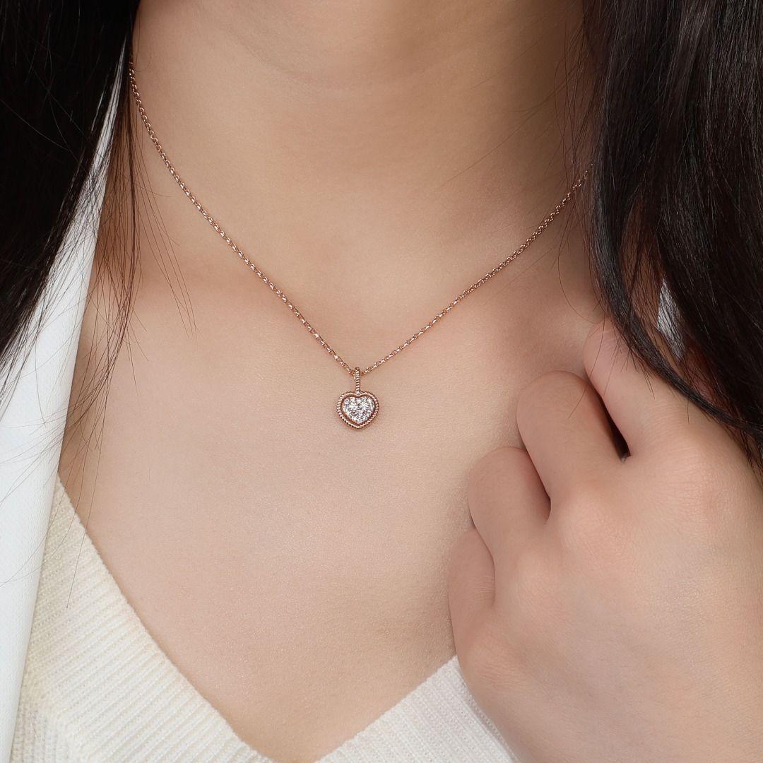 Introducing a delicate and elegant necklace crafted from luxurious 18K rose gold, adorned with three exquisite round brilliant natural diamonds as the main stones, each weighing 0.10 carats. These diamonds boast a stunning F color grade and VVS