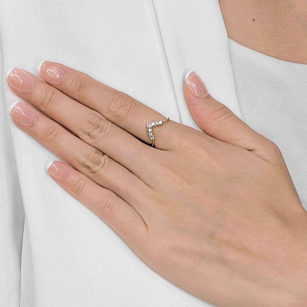 Sleek, chic, and versatile — this V-shaped ring is a stunning blend of modern minimalism and timeless sparkle. Crafted in 14K yellow gold, it features 7 round brilliant-cut natural diamonds totaling 0.35 carats. Each stone is hand-set to form a