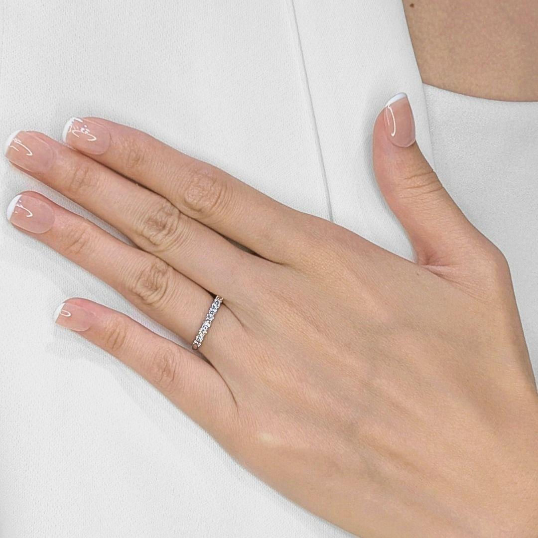 Embrace understated elegance with this exquisite ring. Nine brilliant-cut natural diamonds, totaling 0.36 carats, are meticulously set in a sleek and luminous 18K white gold band. The near-colorless (G/H) diamonds, with their exceptional VS clarity,