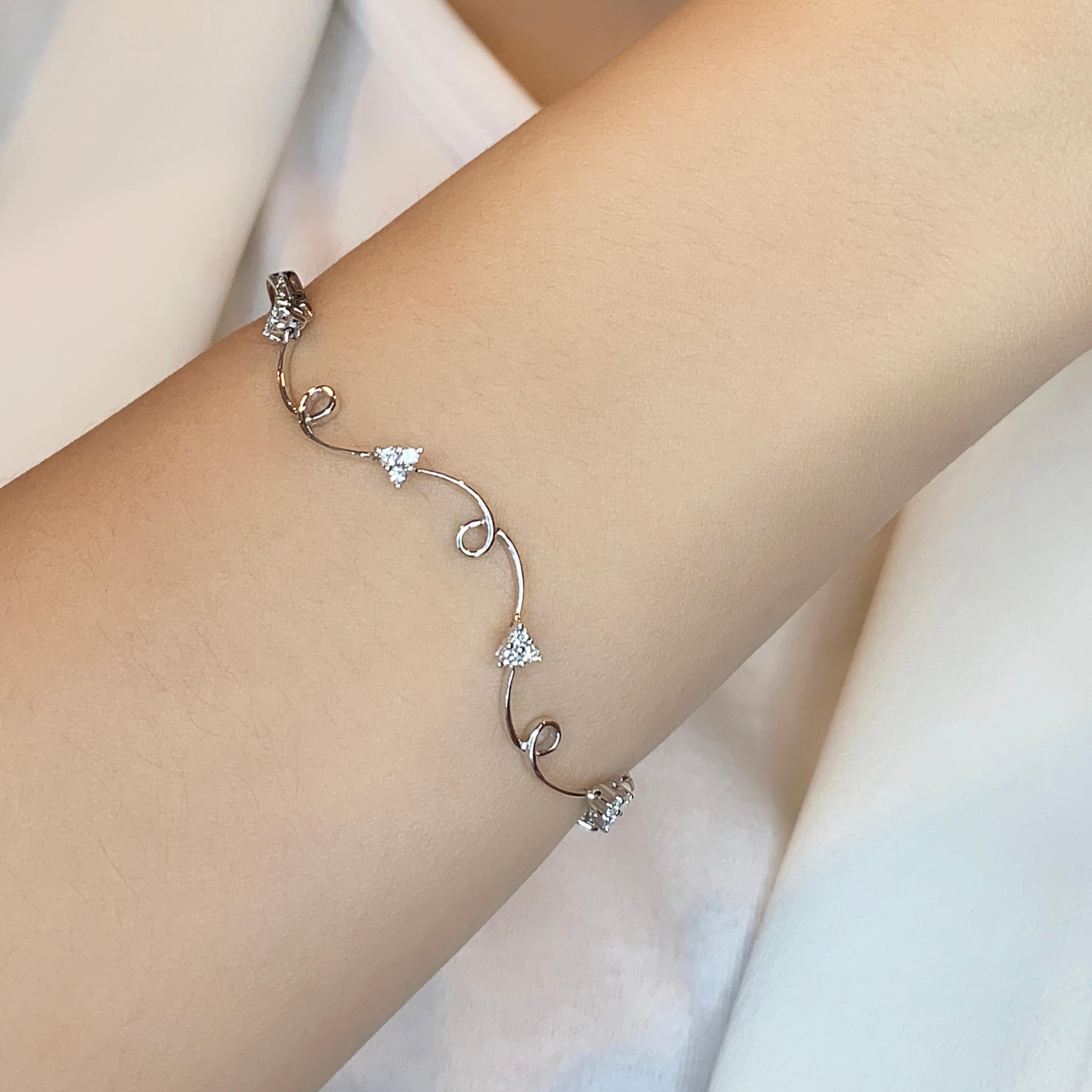 Embrace sophistication with this elegant 18K white gold bracelet, featuring 24 natural diamonds that dazzle with every movement. With a total carat weight of 0.5ct, these round brilliant diamonds boast a stunning G color and VS clarity, ensuring a