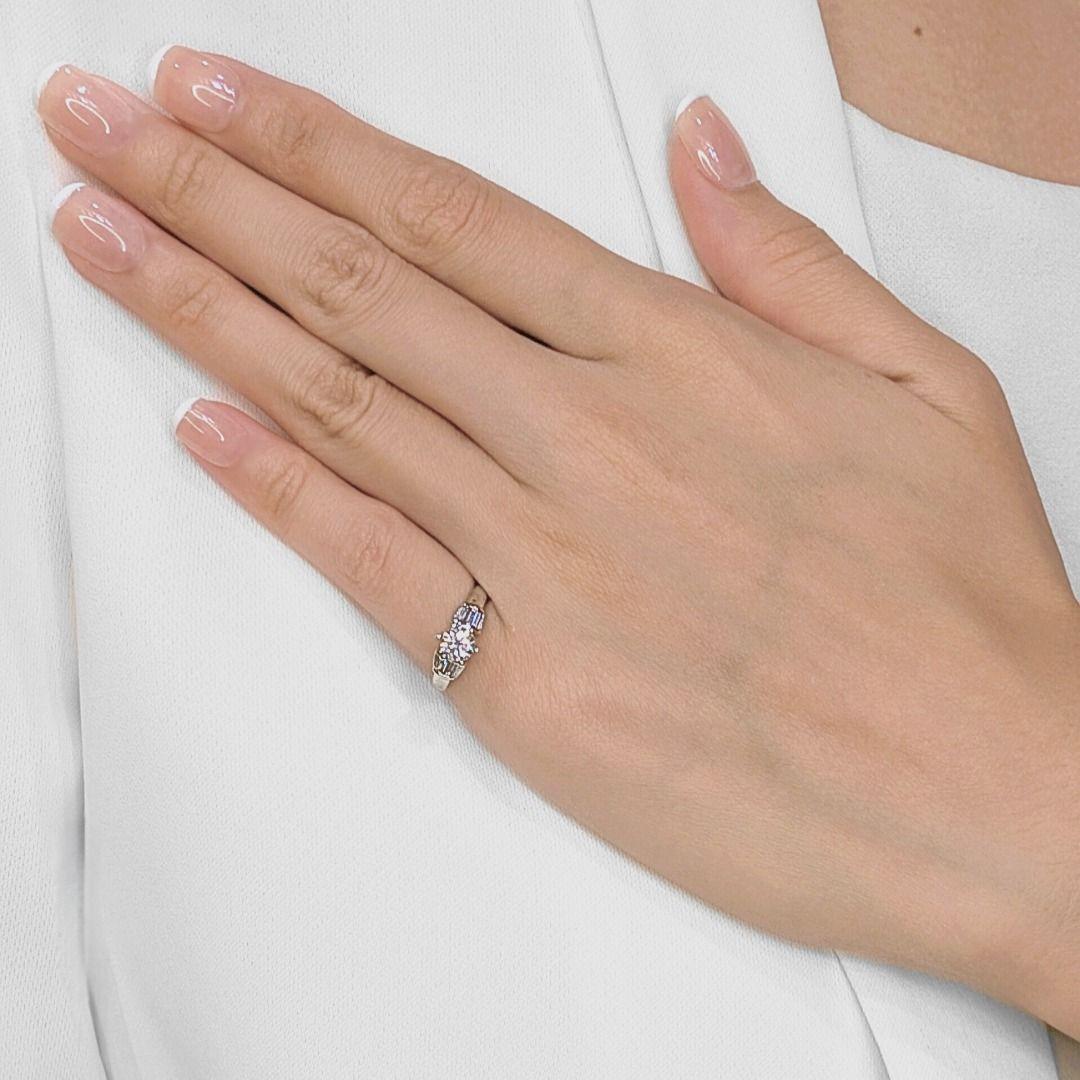 Turn heads with this radiant platinum ring featuring a dazzling 0.48ct round brilliant diamond at its center, perfectly flanked by sleek tapered baguette side stones totaling 0.16ct. The refined setting combines timeless elegance with architectural