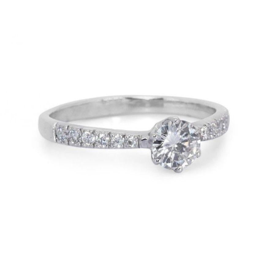 Embrace timeless elegance and mesmerizing sparkle with this breathtaking round diamond ring, showcasing a dazzling 0.72 carat center stone that radiates brilliance and sophistication. Crafted in gleaming 18K white gold, this exquisite piece is
