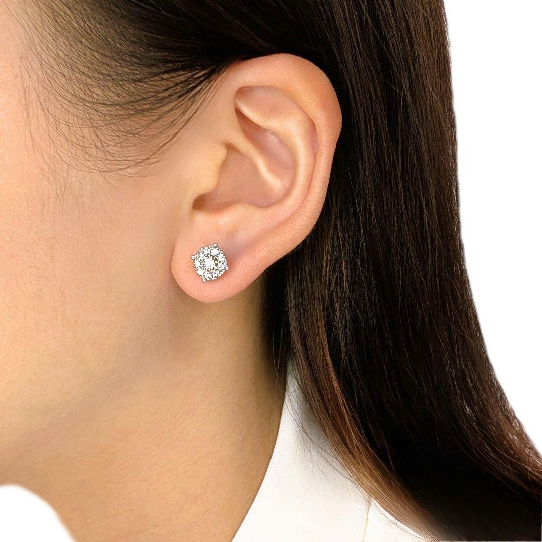 A perfect balance of brilliance and refinement, these halo stud earrings showcase two natural diamonds, totaling 0.36 carats, at the center of a dazzling frame. The 18 surrounding diamonds, adding another 0.36 carats, create an enchanting halo