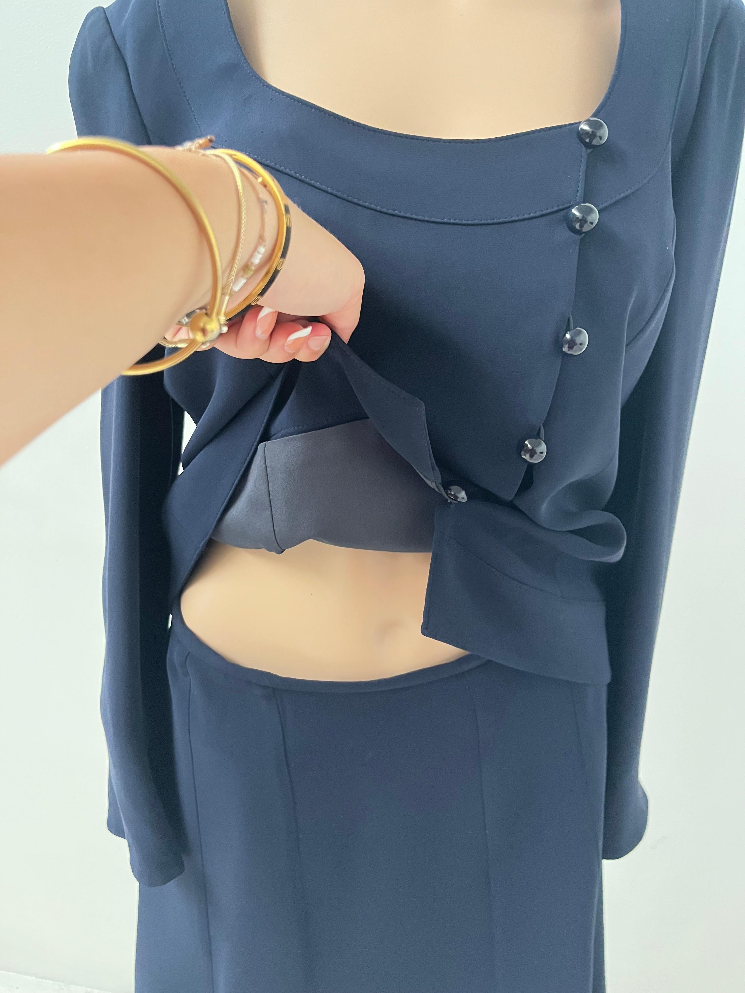 This refined Armani Collezioni two-piece ensemble embodies the timeless sophistication for which the house of Armani is renowned. Crafted in Italy from luxurious 100% silk, this navy blue set includes a beautifully tailored jacket and an elegant