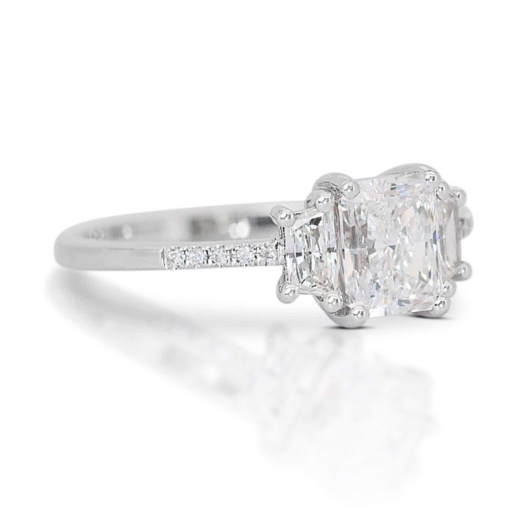 Imagine the sparkle that steals the show. This captivating ring features a dazzling 1.01 carat cut-cornered rectangular modified brilliant diamond, boasting an exceptional E color and VS1 clarity for breathtaking brilliance. Its unique, modern cut