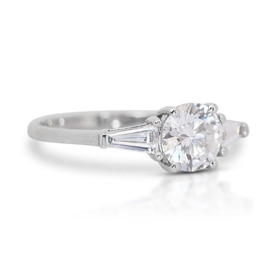 This ring is more than just an accessory; it's a statement piece that embodies timeless elegance and unparalleled brilliance. The D color diamond guarantees exceptional whiteness, while the taper baguettes add a touch of modern flair. Whether you're