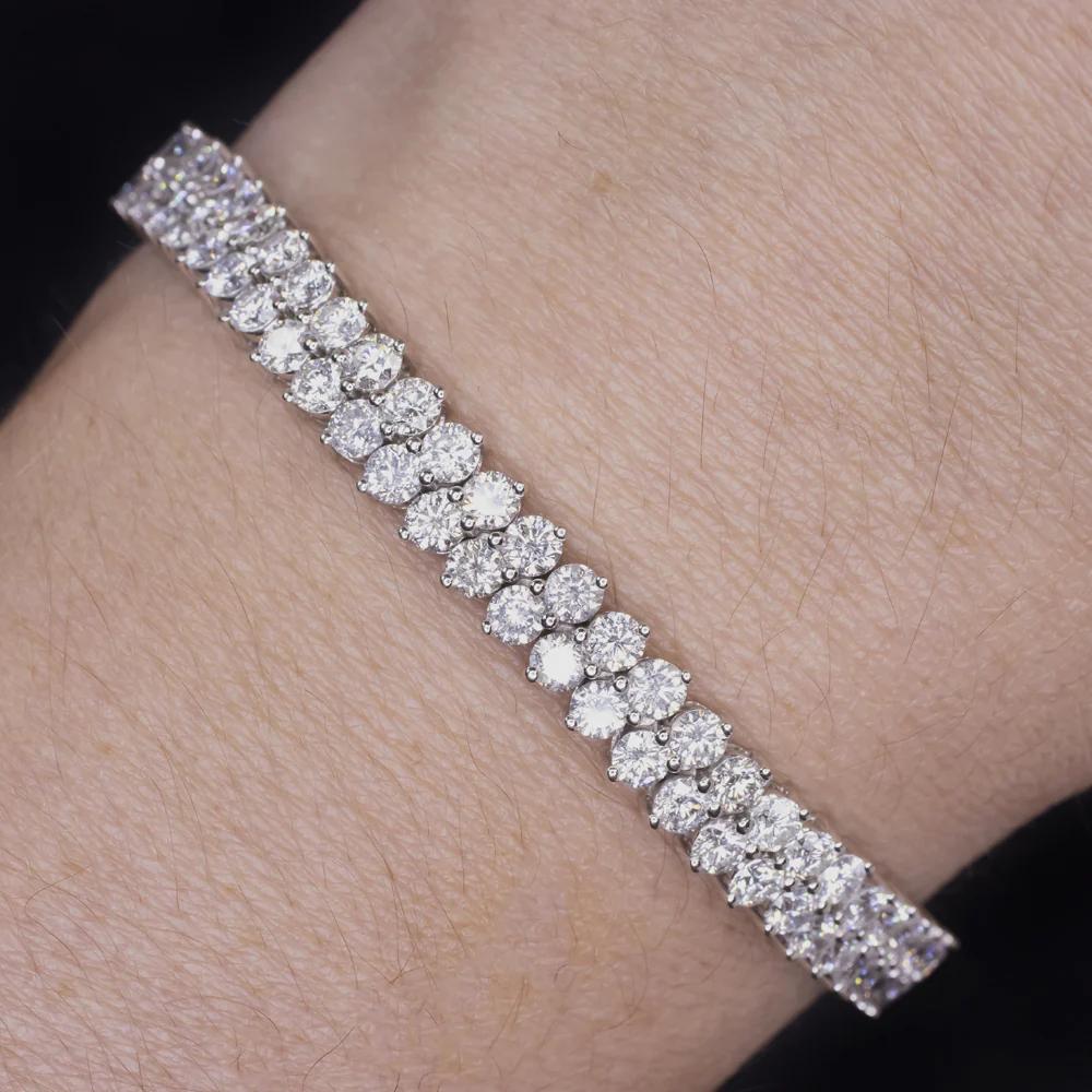 This striking diamond tennis bracelet showcases timeless elegance with a bold twist — featuring a double row of natural round brilliant cut diamonds totaling an impressive 11.00 carats. Each stone is meticulously selected for its exceptional