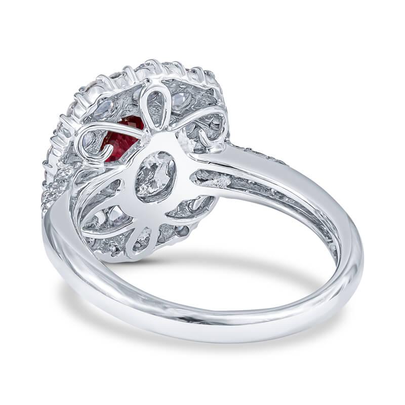 Elegantly designed cocktail or engagement ring featuring a 1.21 carat oval cut faceted ruby, prong set center, set within a halo of rose cut diamonds which is further accentuated by a second halo of round diamonds around the entire perimeter of the