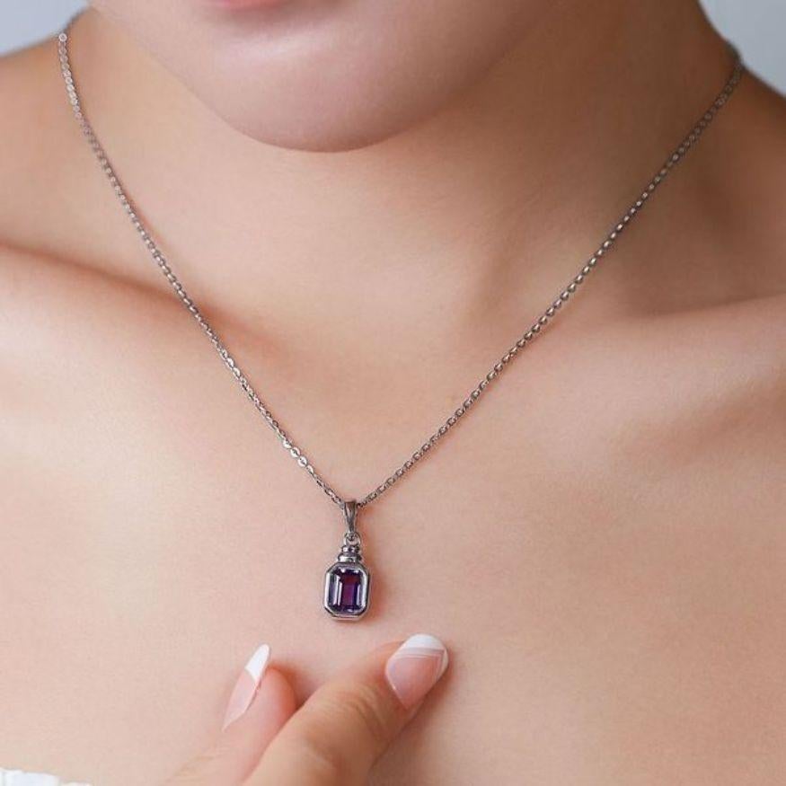 Elevate your style with the enchanting allure of this 18K White Gold pendant, adorned with a captivating amethyst stone at its center. The amethyst, boasting a generous carat weight of 1.29 carats, is skillfully cut into a cushion shape, showcasing