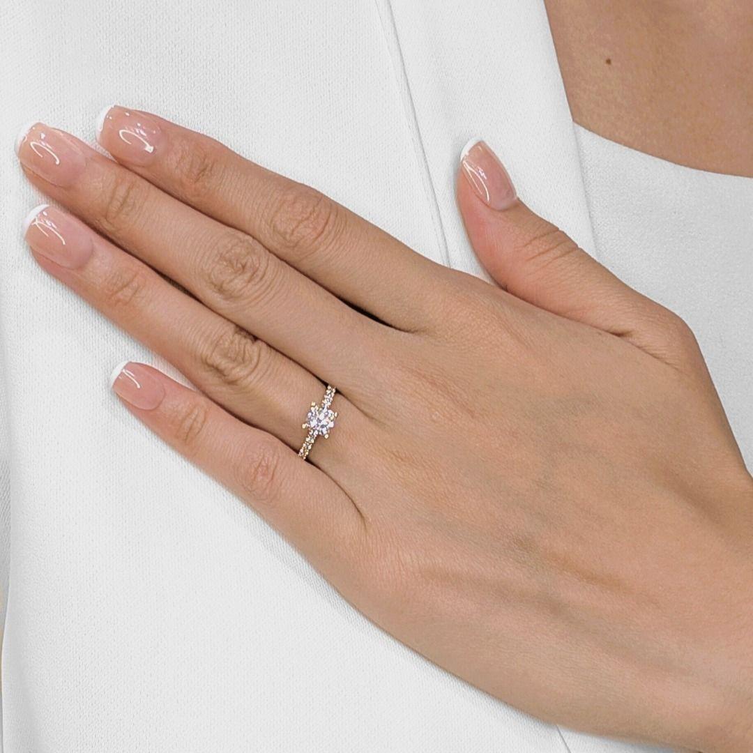 Elegance meets modern romance in this stunning diamond ring, crafted in warm 18K rose gold. At the center glows a 1.00ct natural cushion-cut diamond, graded F/VS1 and GIA certified for assured quality and brilliance. Accentuating the band are 18