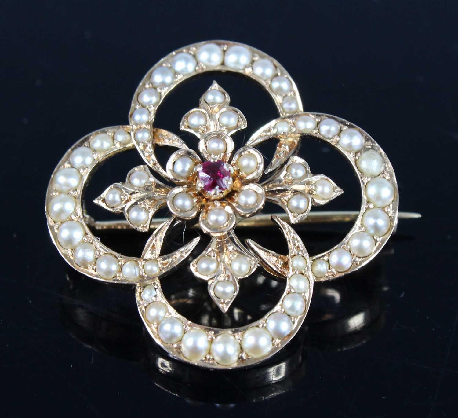 Elegant 14K Gold Ruby and Seed Pearl Crescent Floral Brooch with Fleur-de-Lis Inlaid Design

This exquisite brooch probably dates back to circa 1900 or later and is a testament to craftsmanship. Crafted in solid 14K yellow gold, the brooch weighs